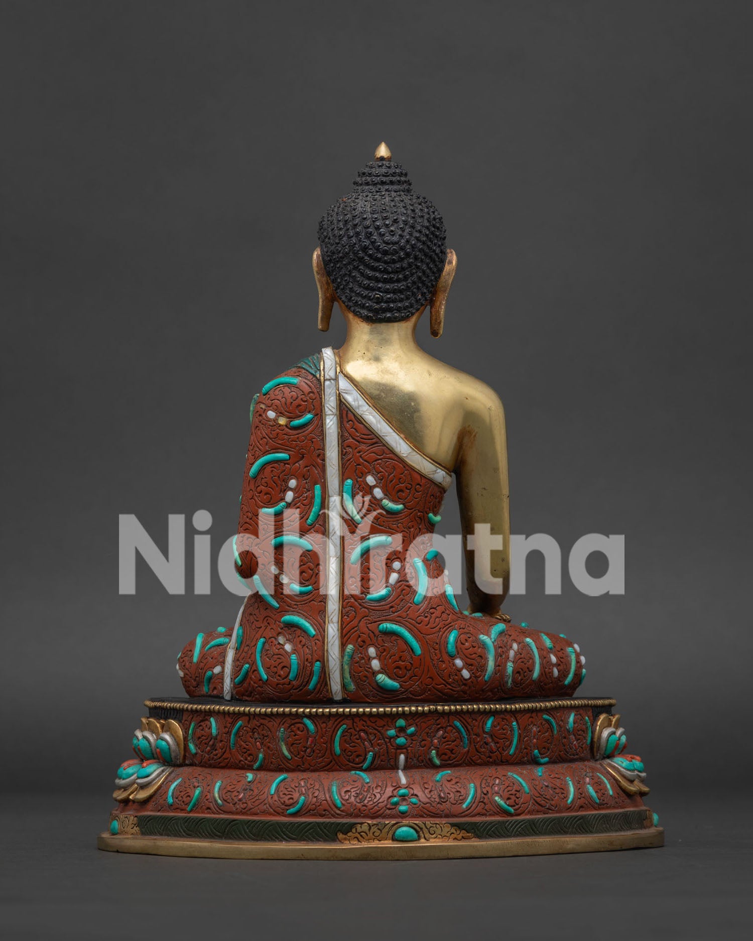 Back view of Shakyamuni Buddha copper statue with hand carved robe detailing and vajra lotus throne Nepal