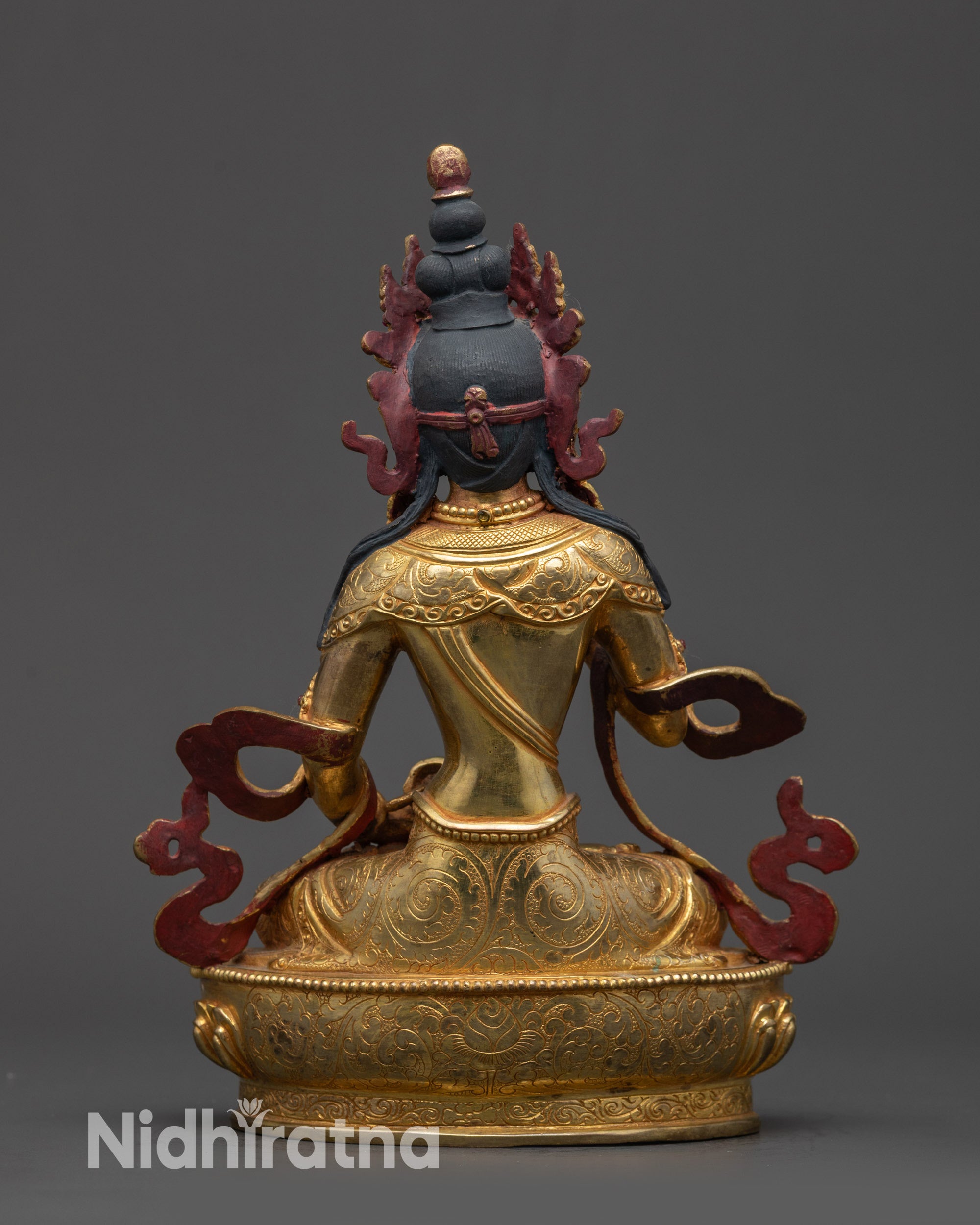 Back view of gold fire-gilded Vajrasattva statue highlighting carved garments and crown