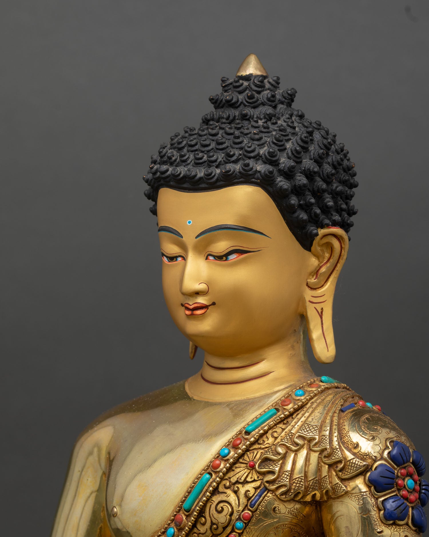 amitabha buddha side detail close up, gold gilded robe carving with stone inlays