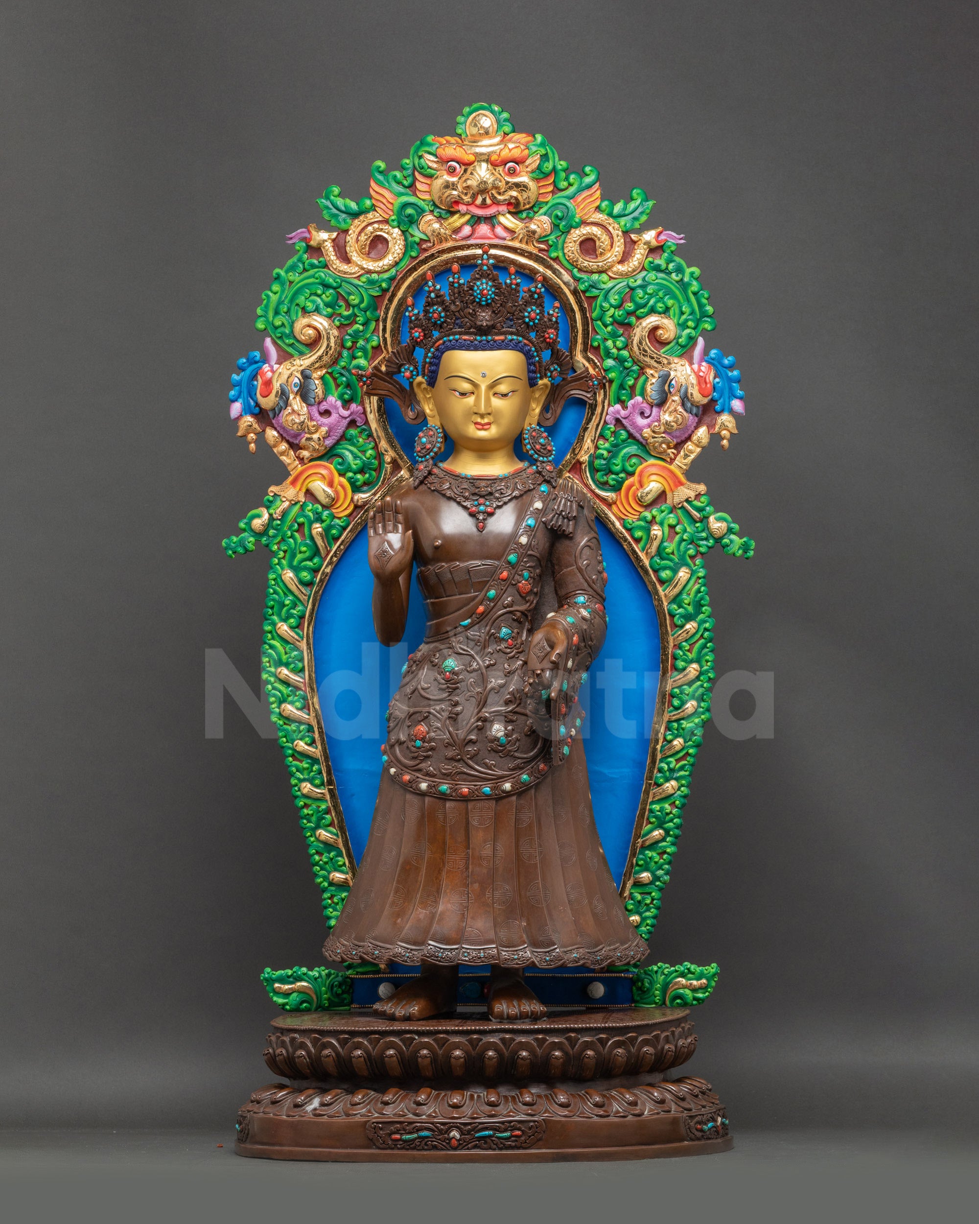 Front view Dipankara Buddha statue standing posture, oxidized copper with gold-painted face