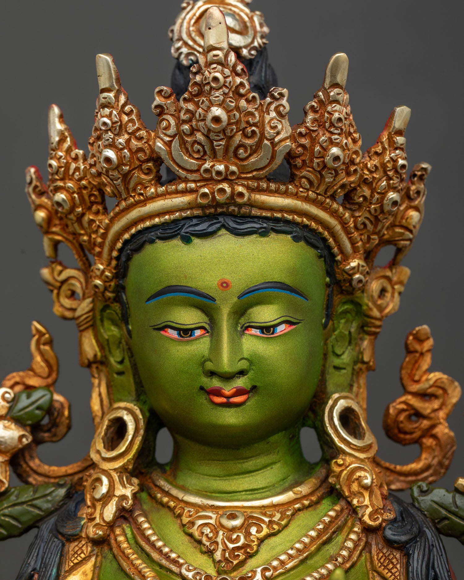Face-close-up-Green-Tara-Bodhisattva-serene-expression-gold-highlights