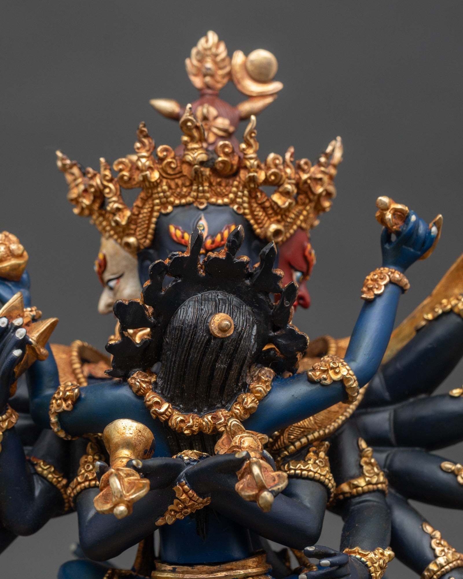 Face close up of Chakrasamvara with consort, gold details and serene expression