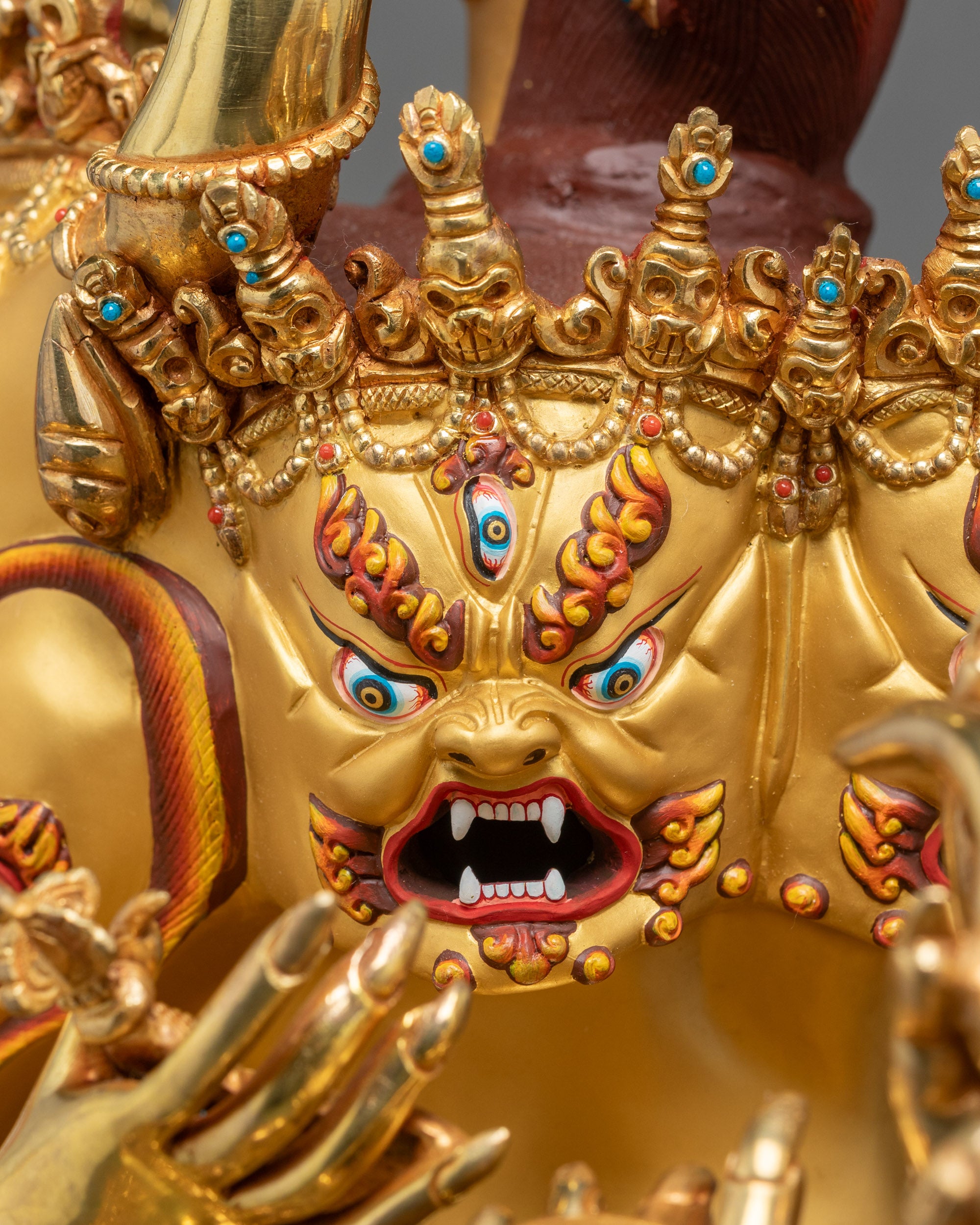 Face detail of Vajrabhairava Union Statue with gold-painted expression and sacred ornaments