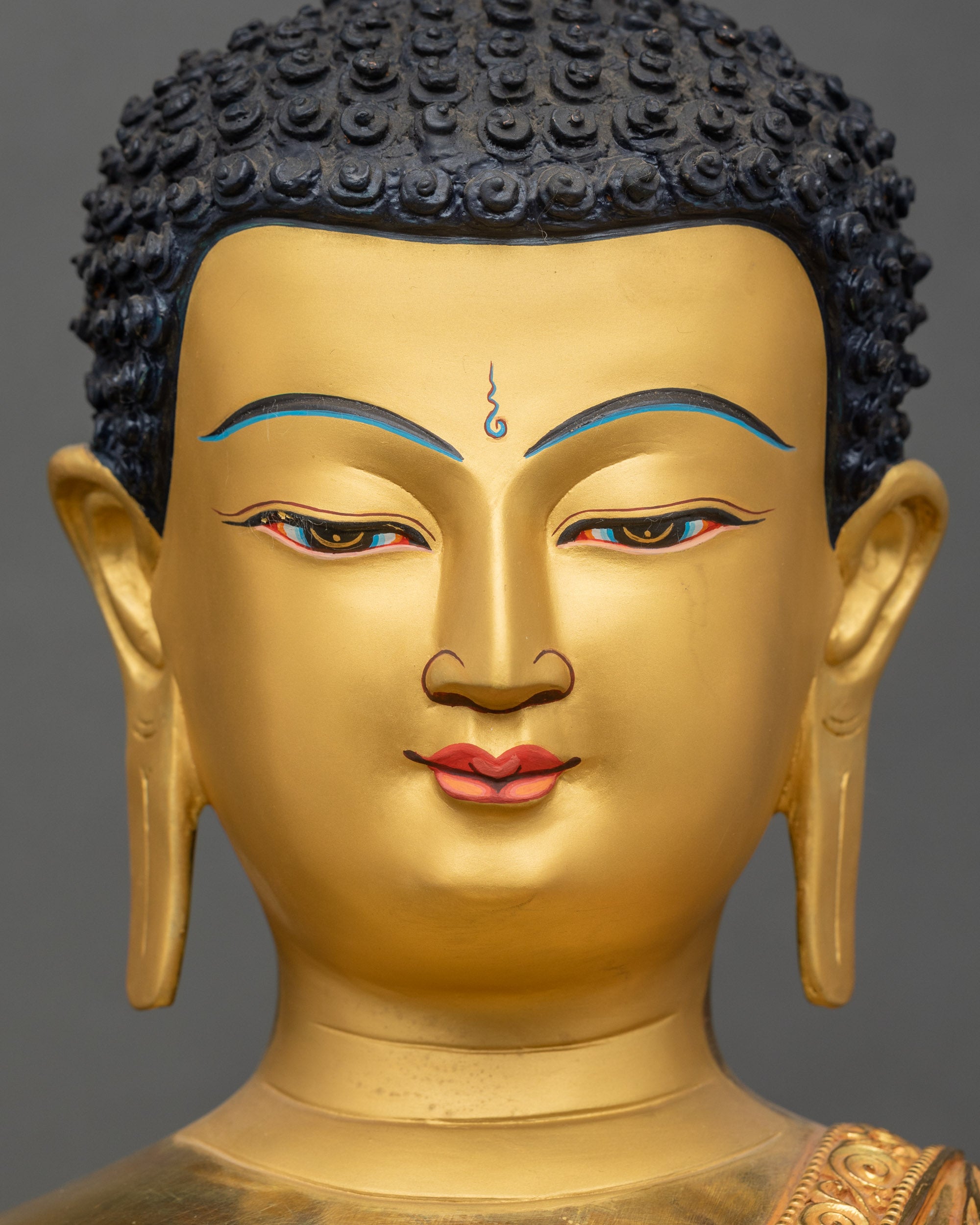 Face of Shakyamuni Buddha, peaceful expression, gold-painted features, and intricate halo detail
