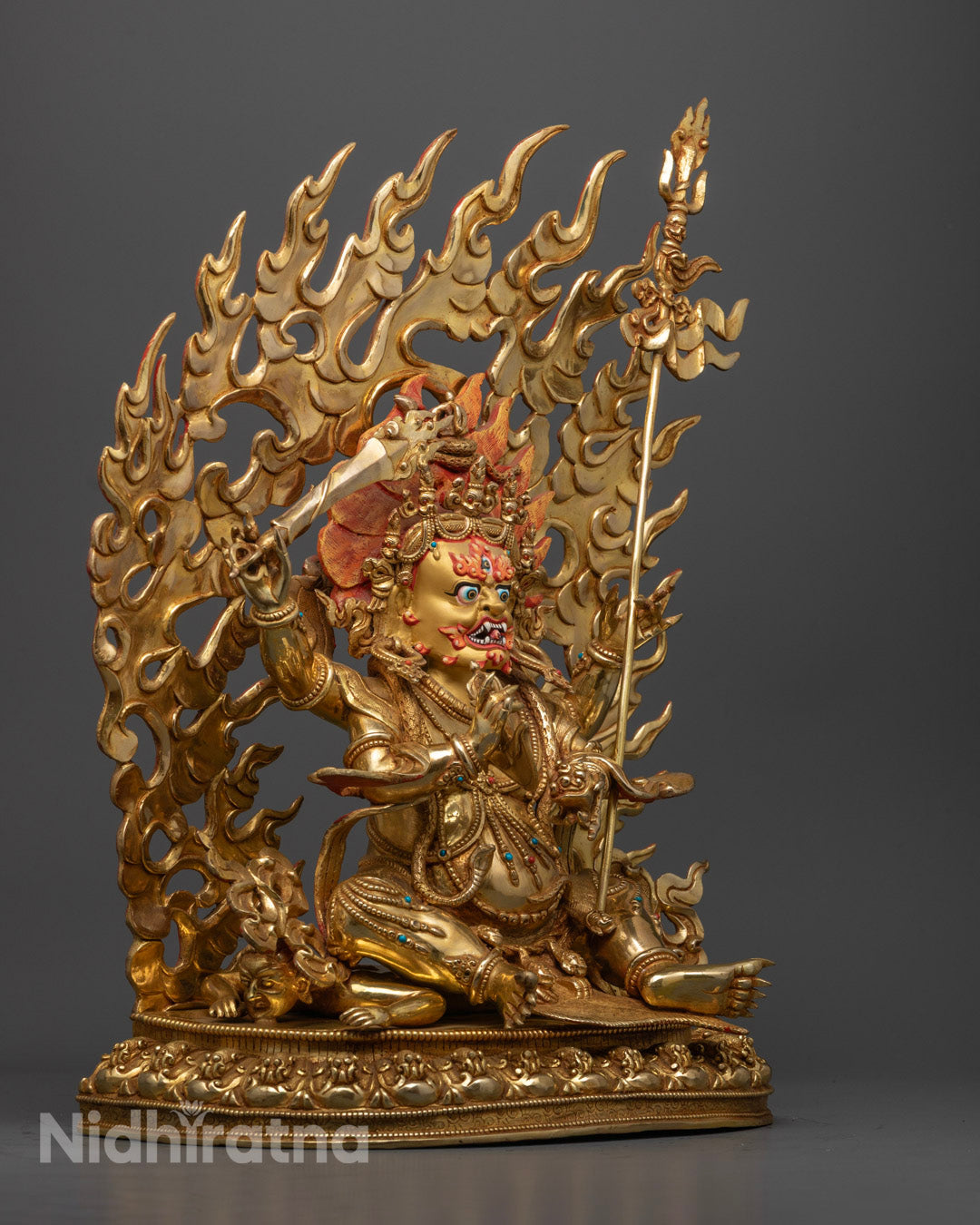 Fierce Four-Armed Mahakala statue showcasing traditional fire-gilding and intricate craftsmanship