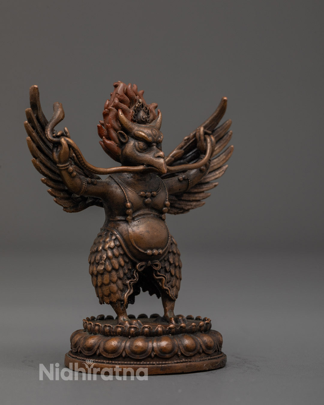 Fierce Garuda statue with vibrant acrylic colors and finely carved wings detail