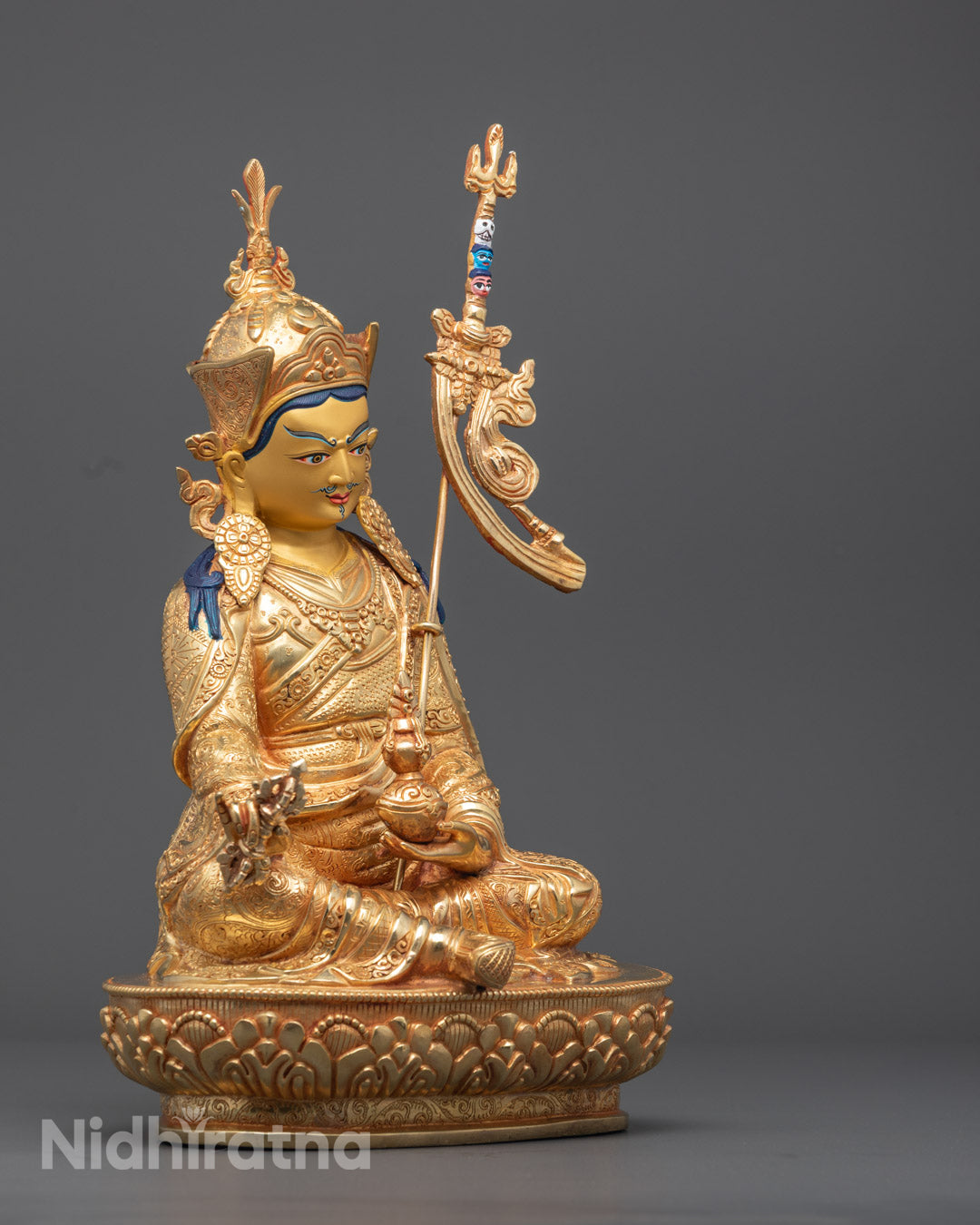 Finely carved dhonka robe, jewelry, and sacred ornaments on Guru Rinpoche statue – traditional lost wax method Buddhist craftsmanship