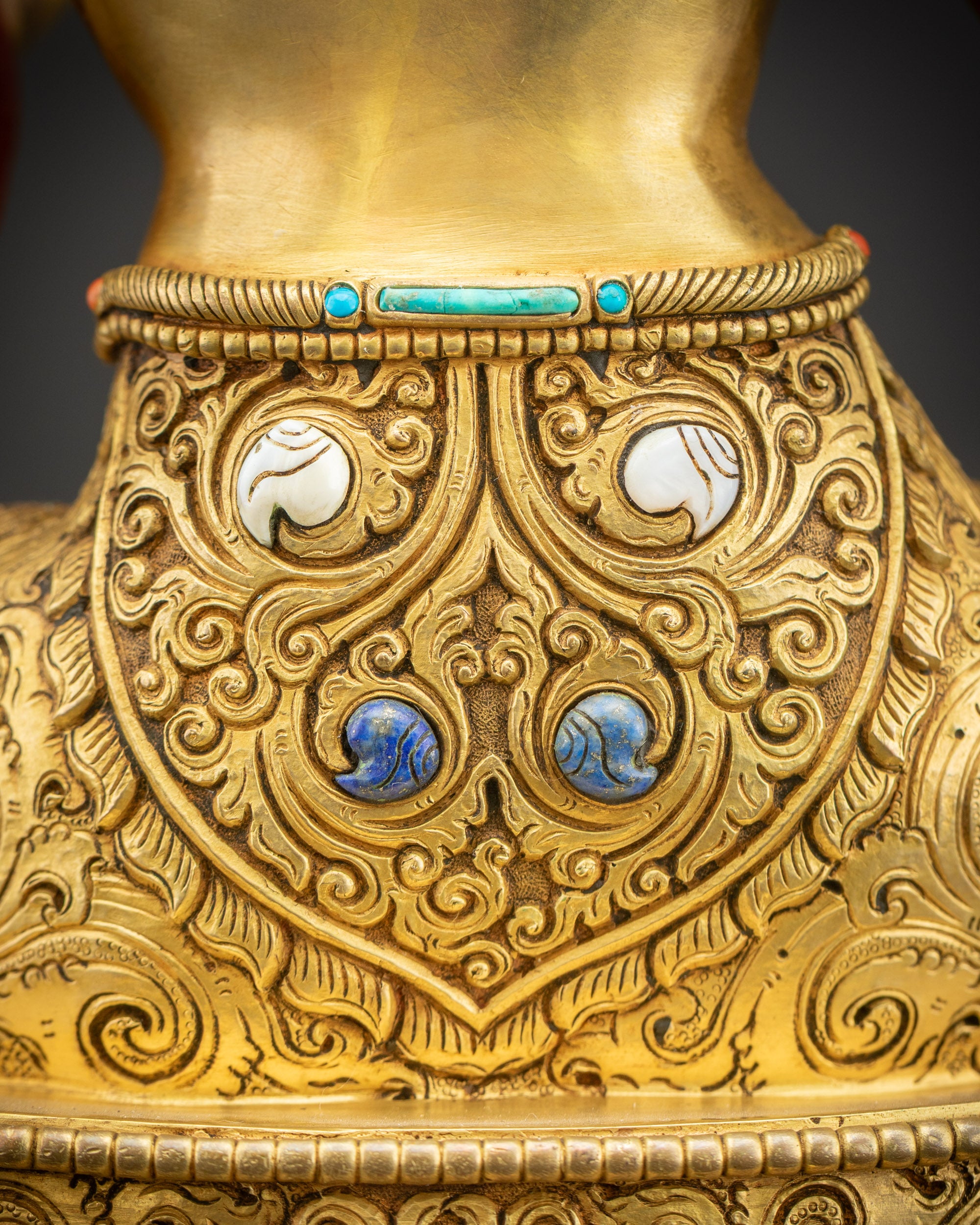 Floral motifs close up on Green Tara Statue with detailed carvings and gold accents