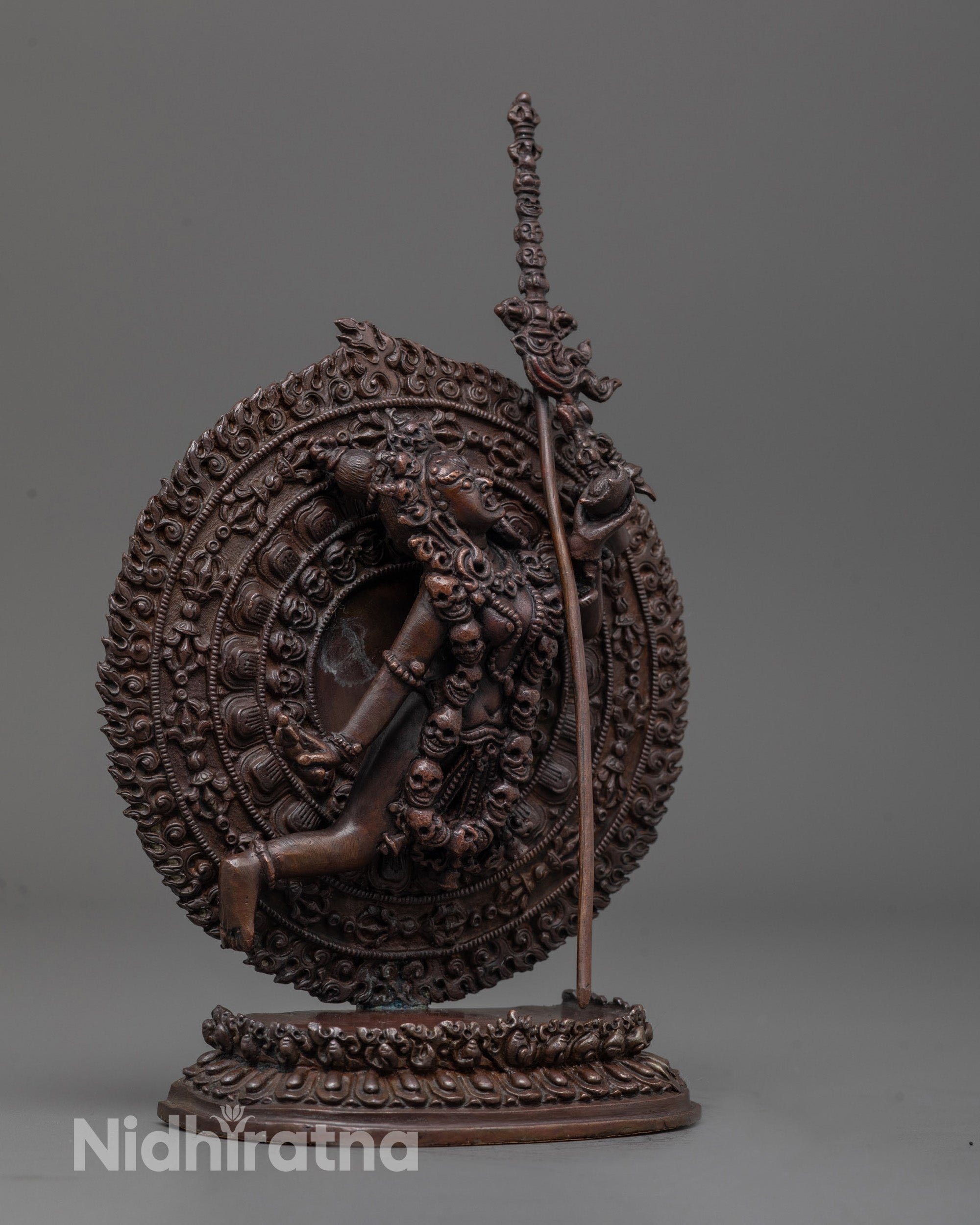 side angle of dynamic flying posture with flowing robes on oxidized copper Vajrayogini statue