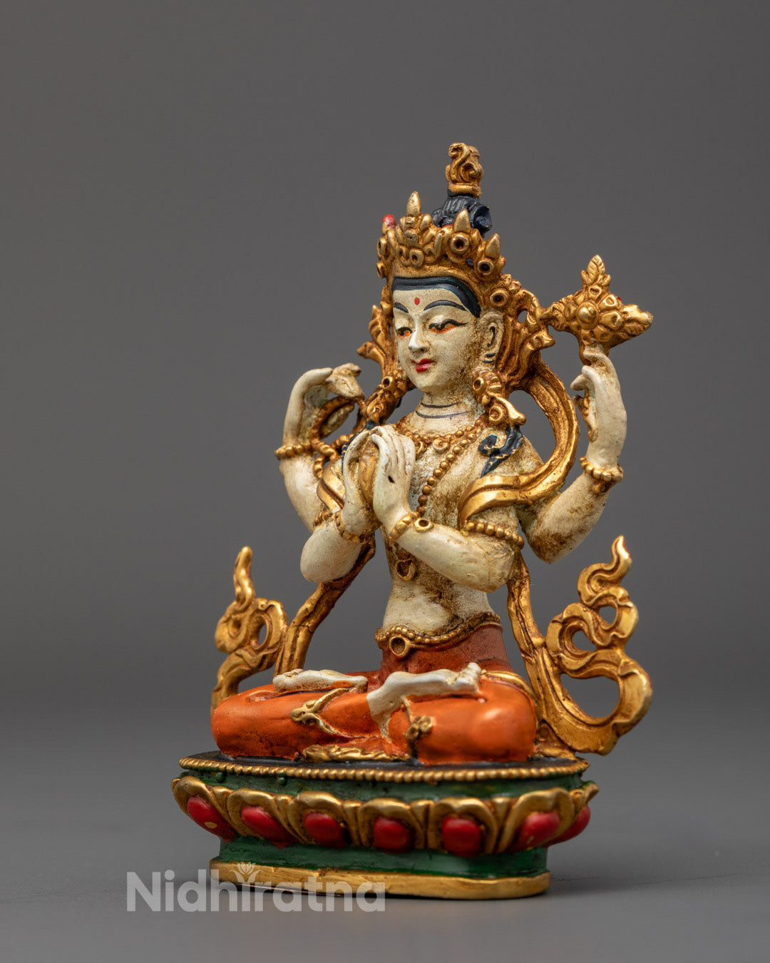 Four-Armed Avalokitesvara Statue holding mala, utpala flower, and wish-fulfilling gem, embodying protection, compassion, and spiritual awakening.