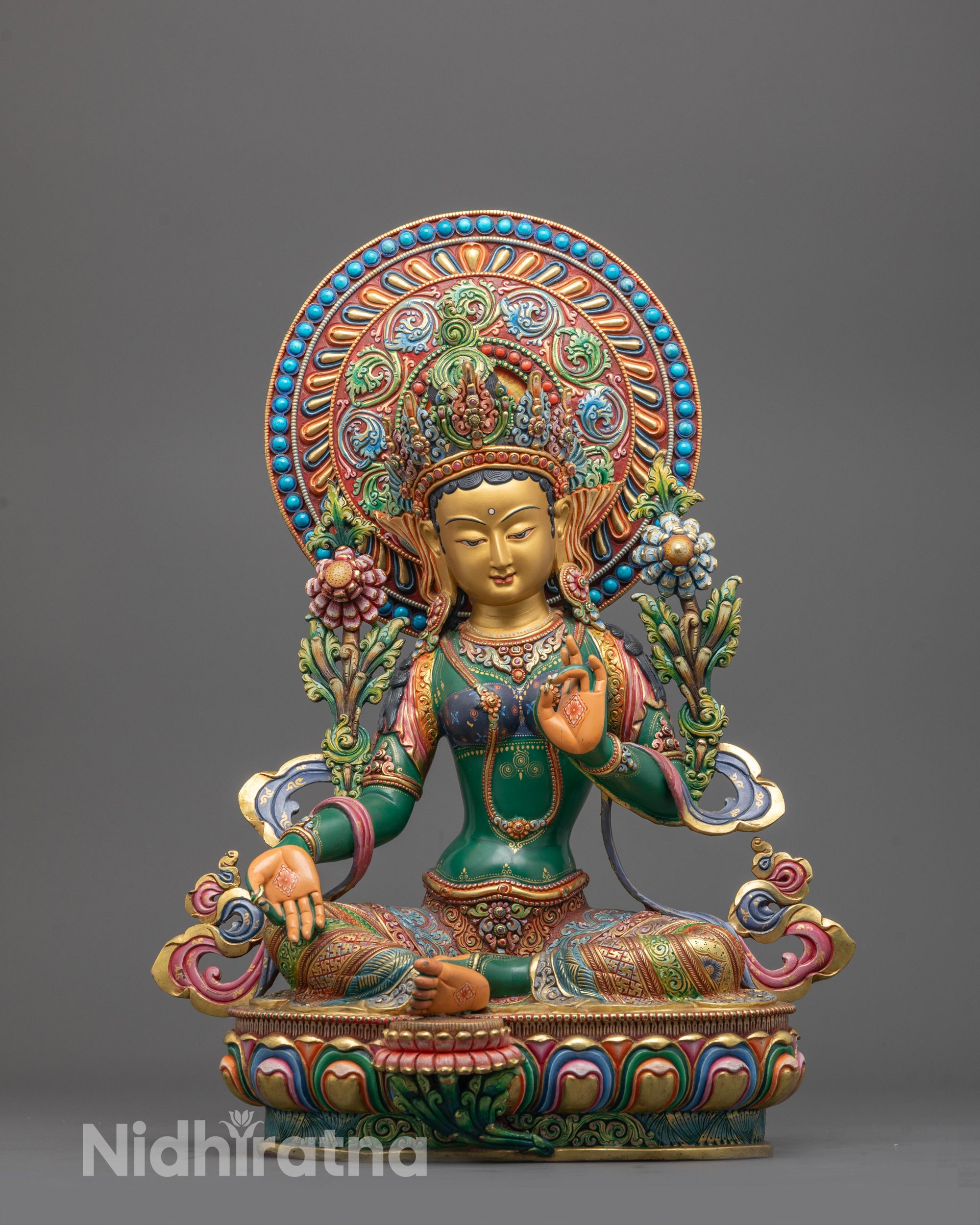 Front-facing Green Tara statue seated in meditative posture on lotus base