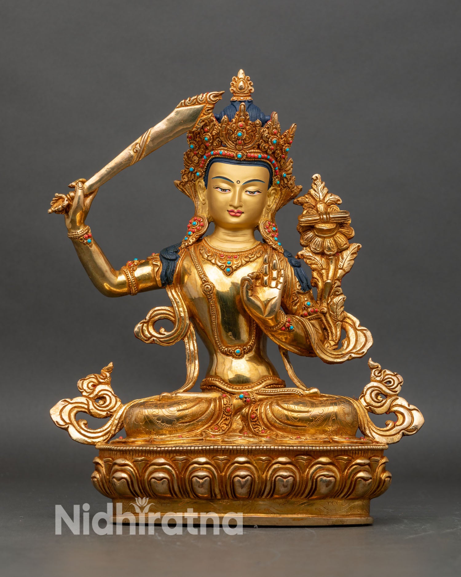 Front view of Bodhisattva Manjushri pure gold statue seated on lotus pedestal Himalayan art