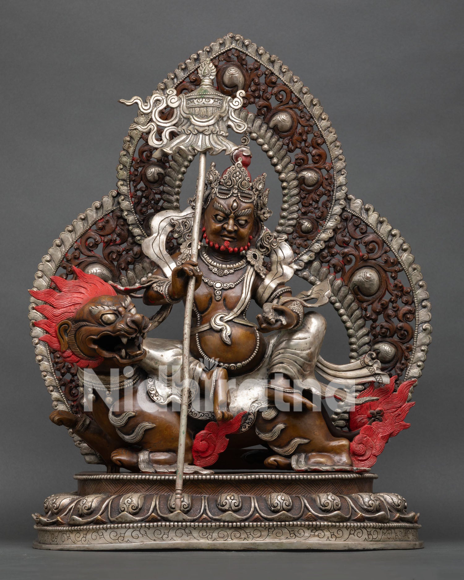 Front view of Vaishravana Namtoshe statue seated on snow lion with victory banner and mongoose