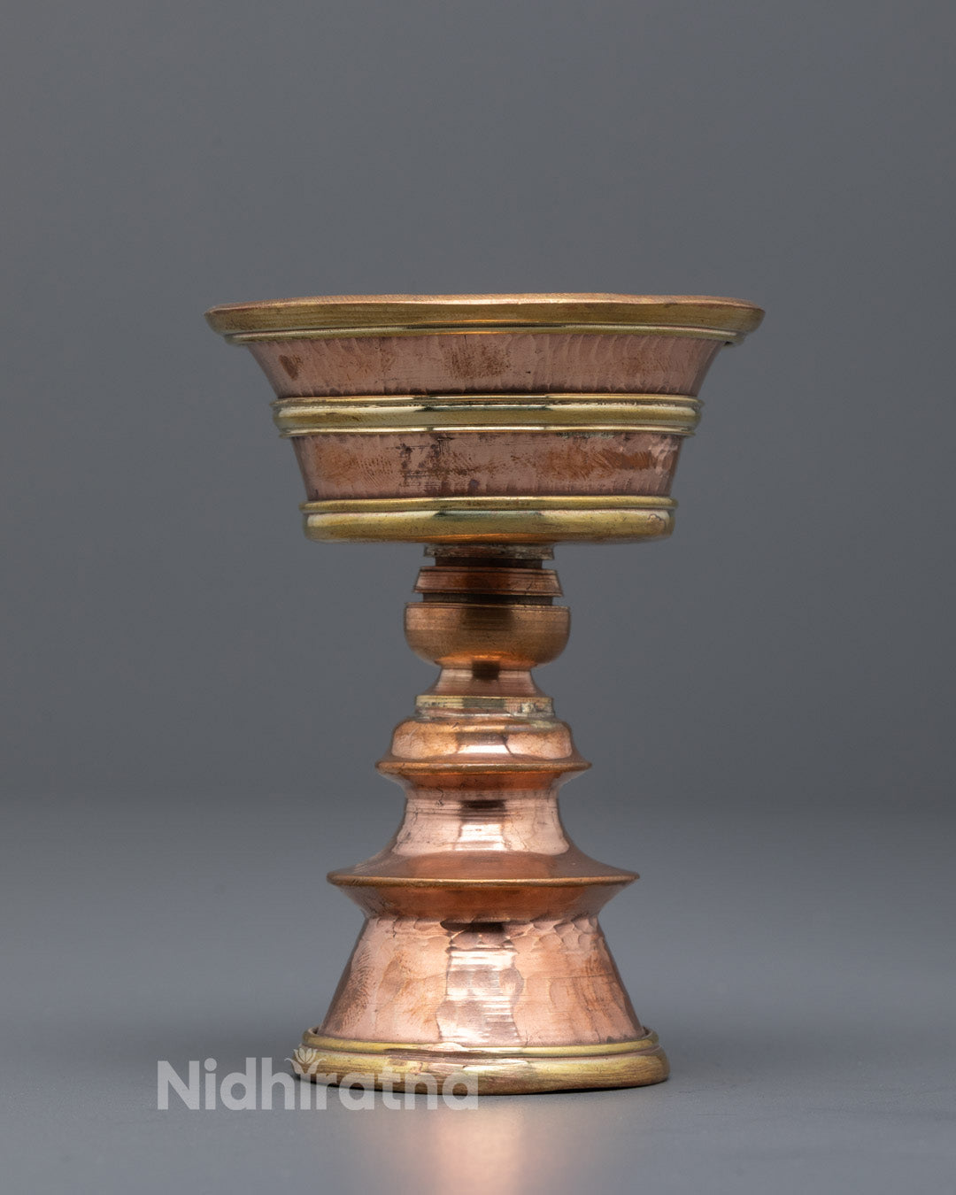 Front-view Artisan-crafted copper butter lamp from Nepal with intricate hammered details