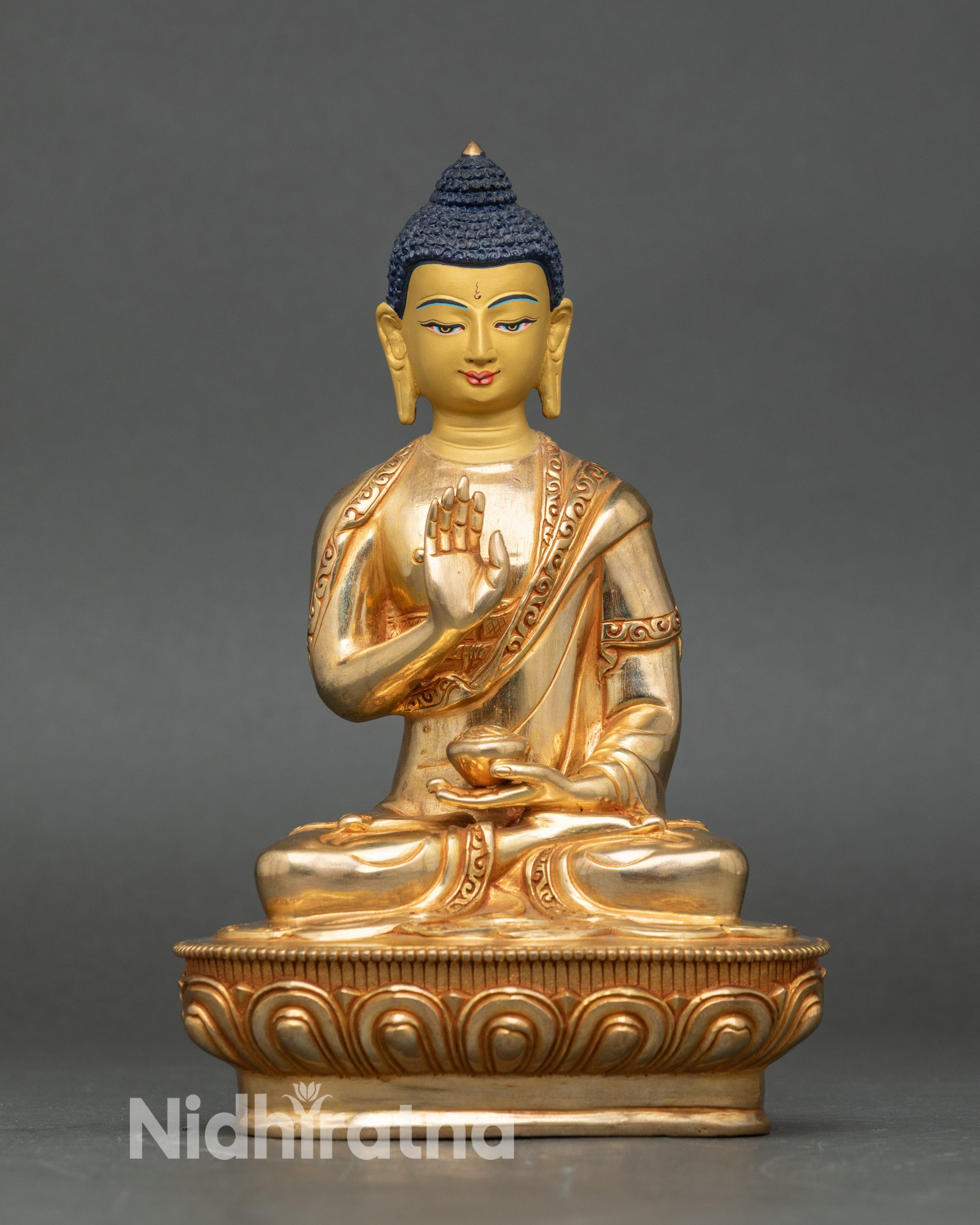 Front view Amoghasiddhi statue, gold-detailed copper, Abhaya Mudra, lotus pedestal Nepal