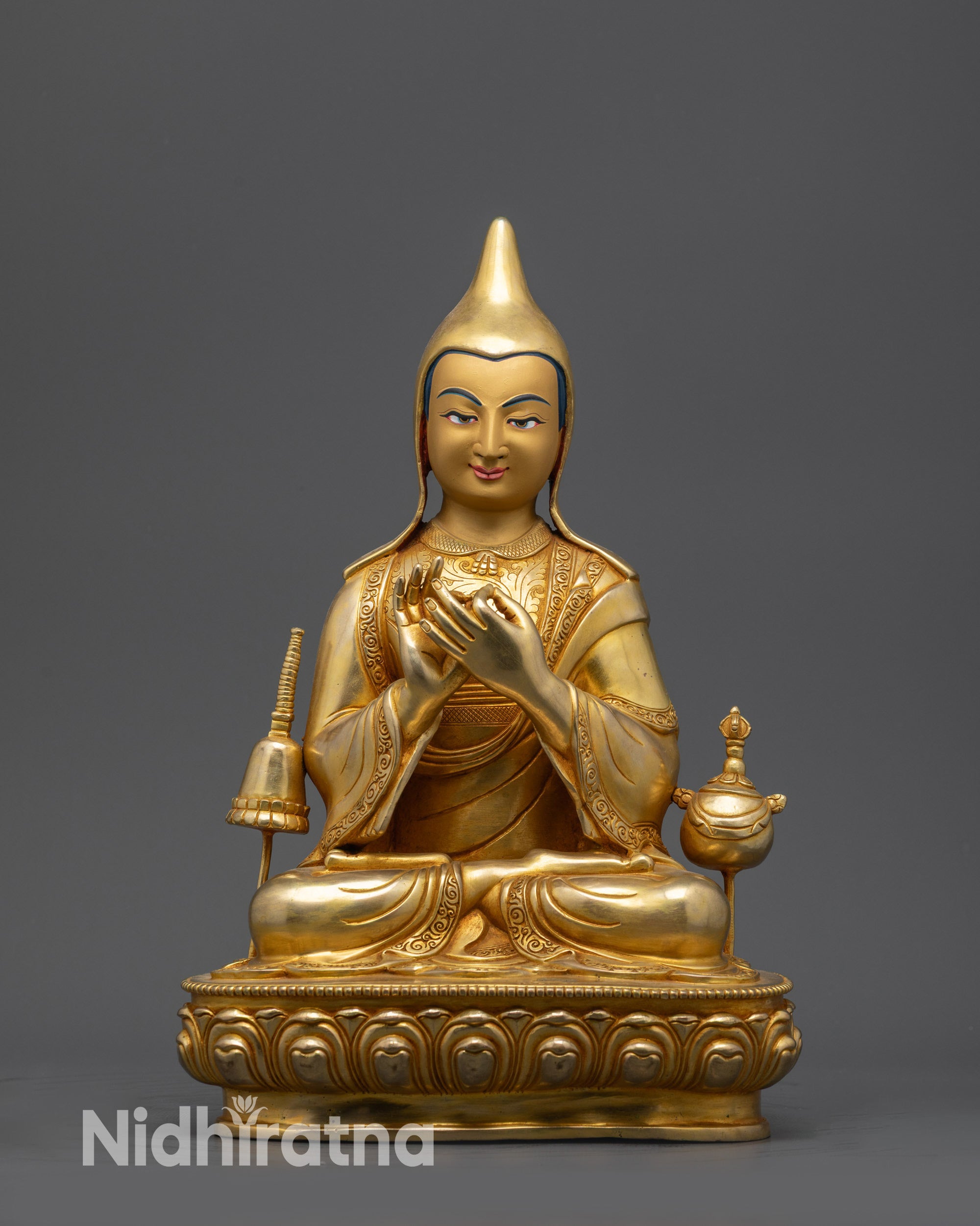 Front view Dipankara Atisha statue with gold-gilded face and lotus posture