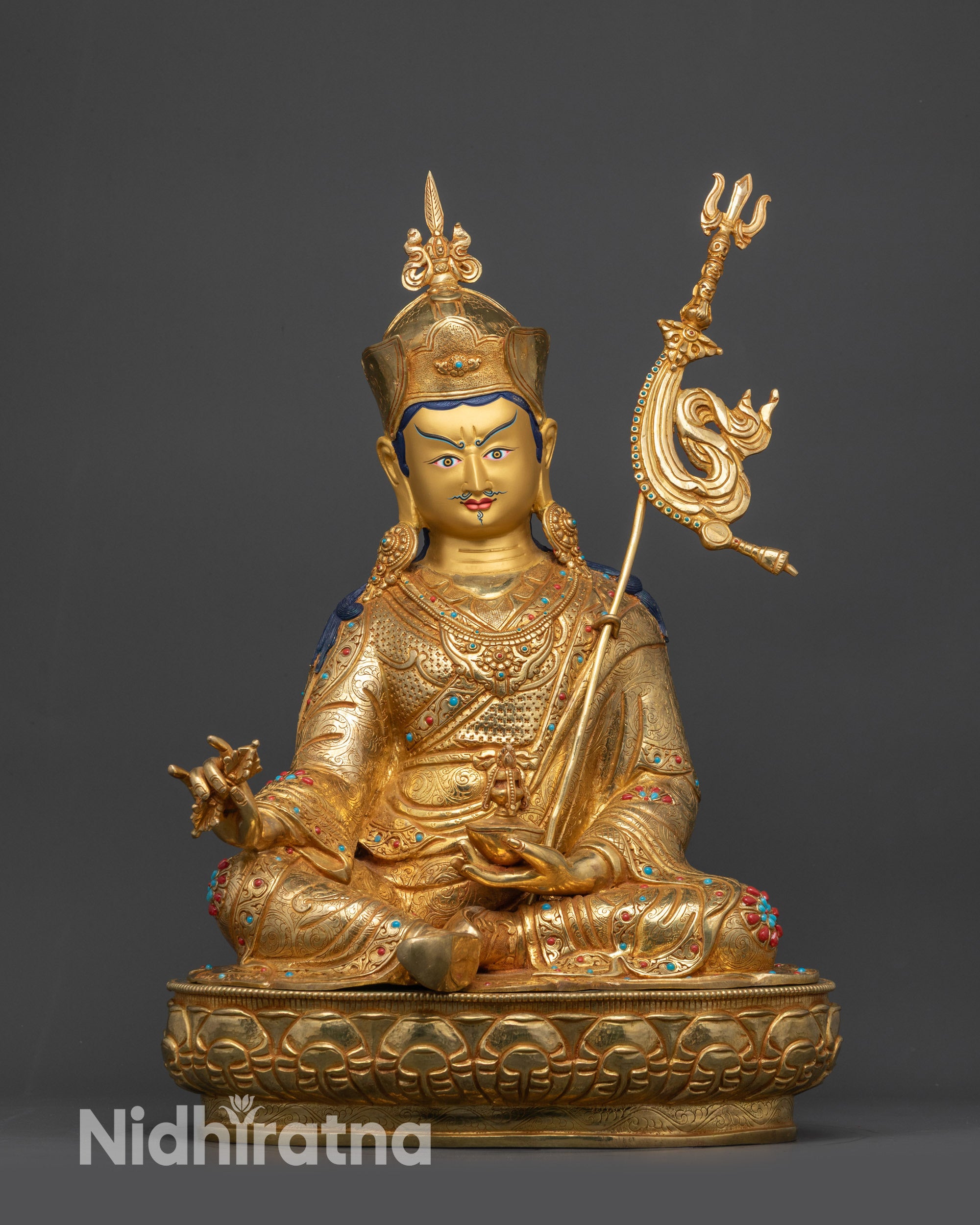Front view Divine Padmasambhava statue on gold fire-gilded base seated on lotus
