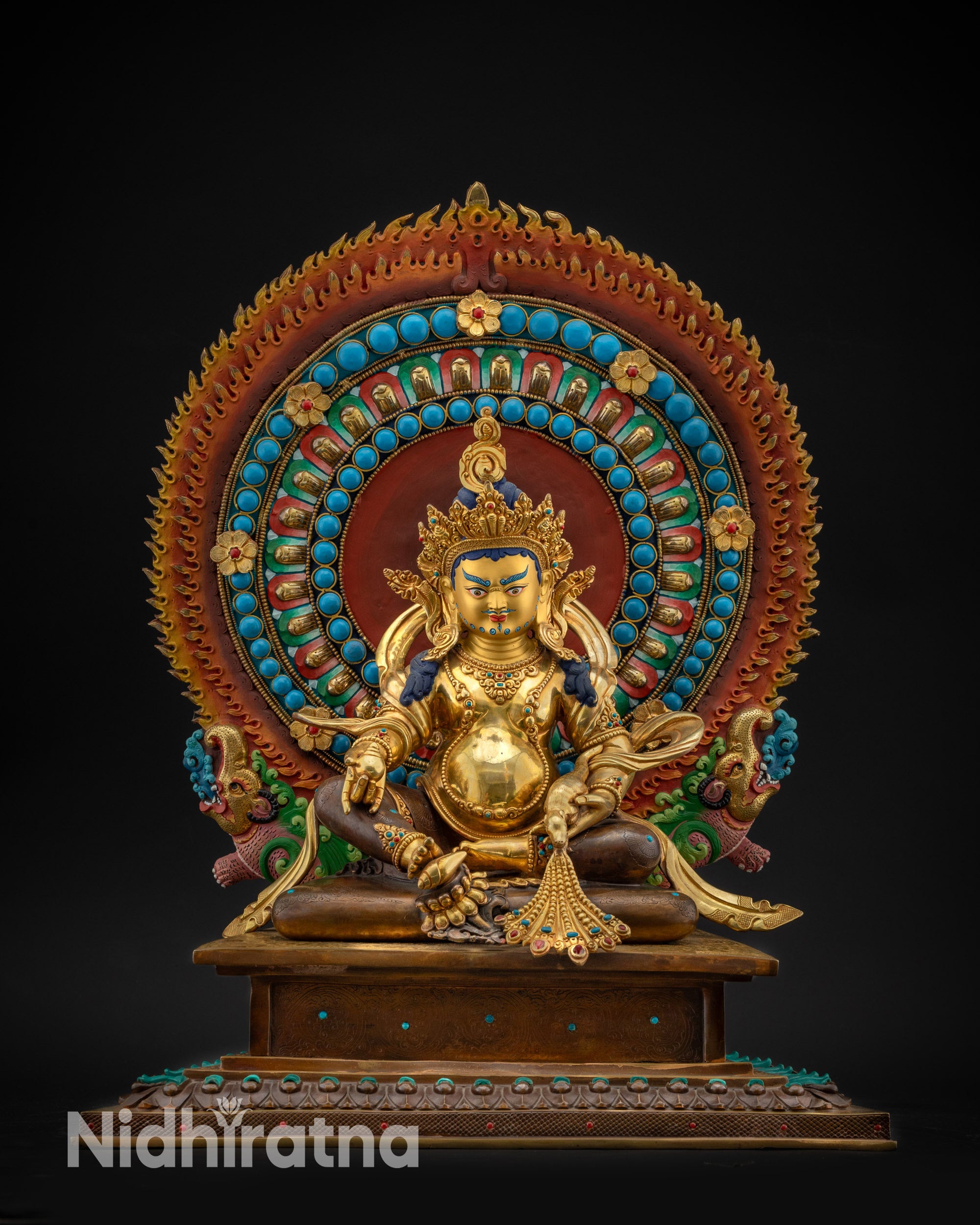 Front view Dzambhala statue on oxidized copper throne holding mongoose and citron fruit