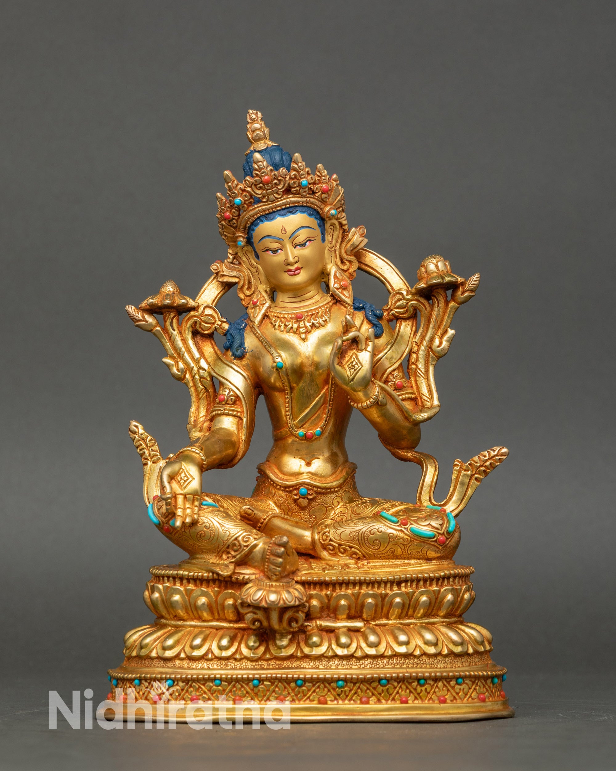Front view Green Tara statue, gold with coral and turquoise, seated on double lotus seat Nepal