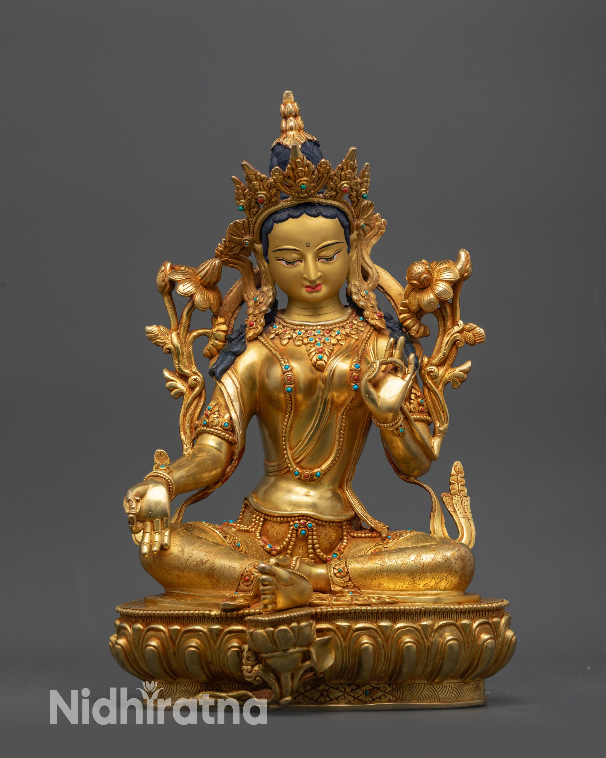 Front view Green Tara statue on lotus seat with gold-gilded face and Utpala flower