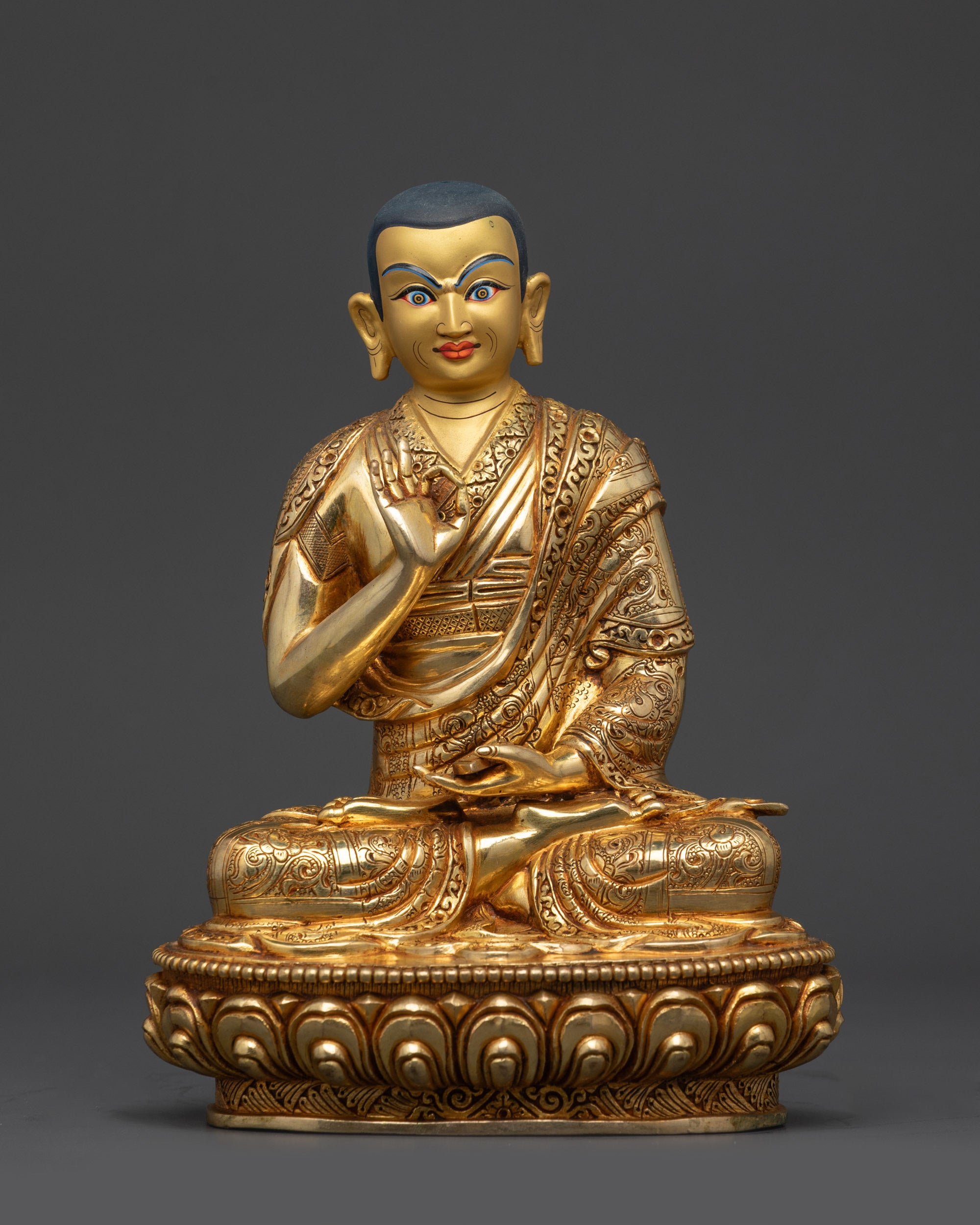 Front view Khedrup Je disciple statue holding scriptures in Vitarka Mudra