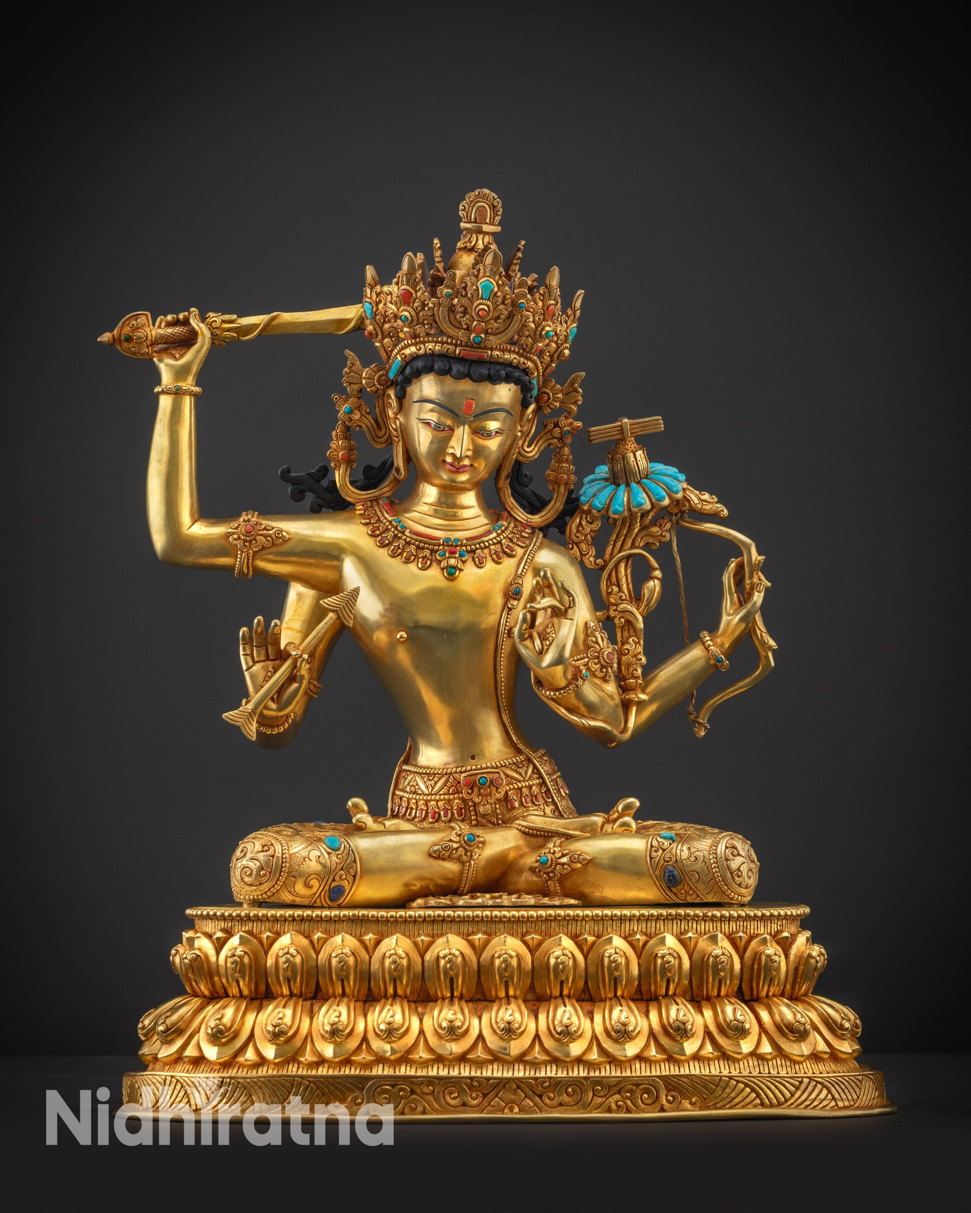 Front view Maha Manjushri statue showing jeweled crown, jewelry, and serene meditative face.