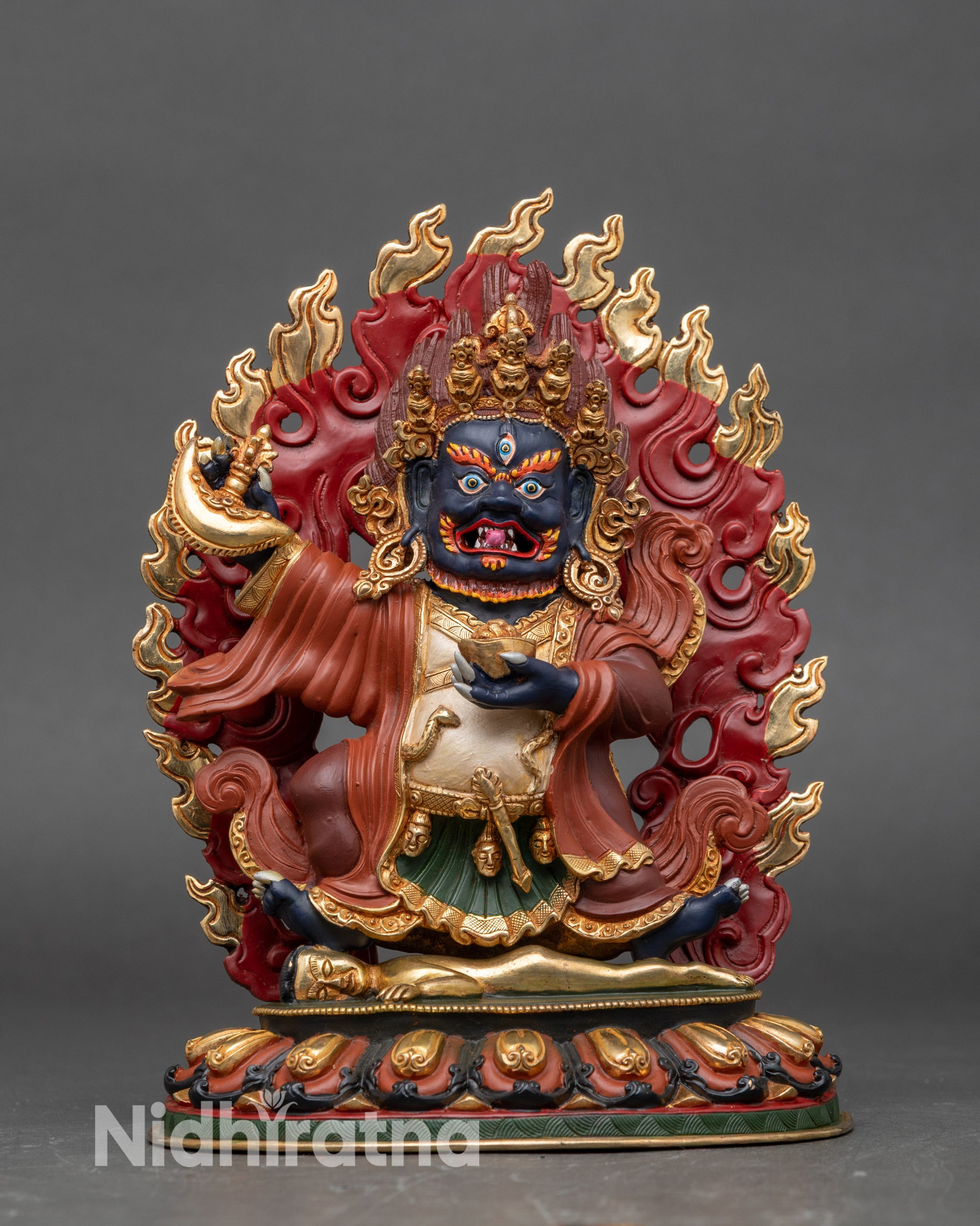 Front view Mahakala Bernagchen statue on lotus seat, copper with gold gilding and vibrant colors