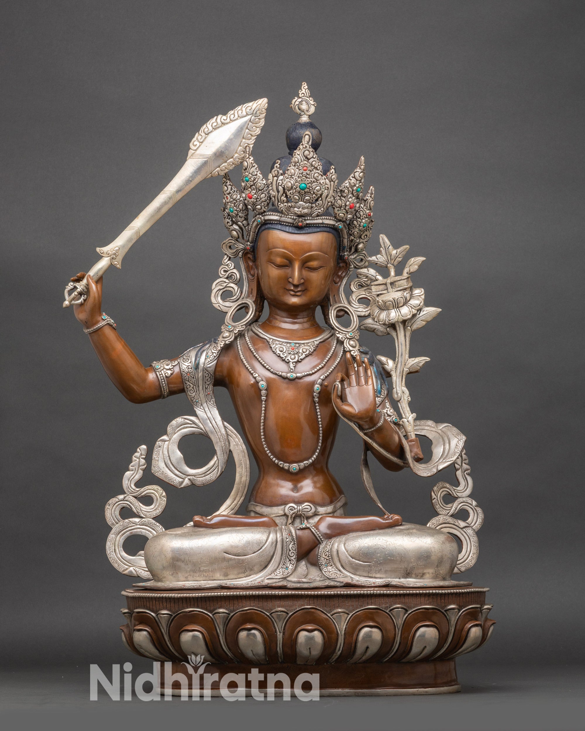 Front view Manjushree Bodhisattva statue in Nepalese copper with wisdom sword and lotus