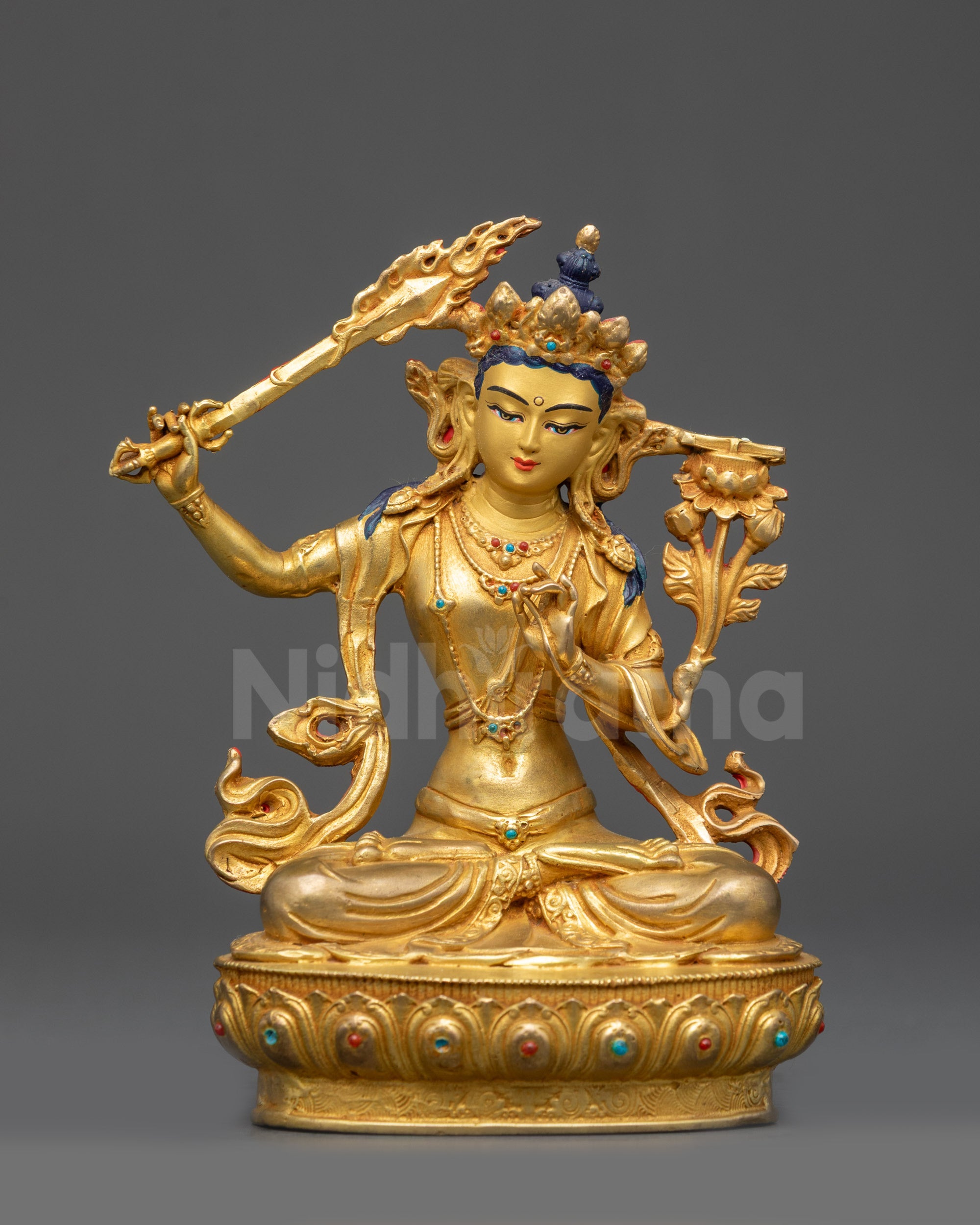 Front view Manjushri Statue seated on lotus with gold-gilded face and flowing robes