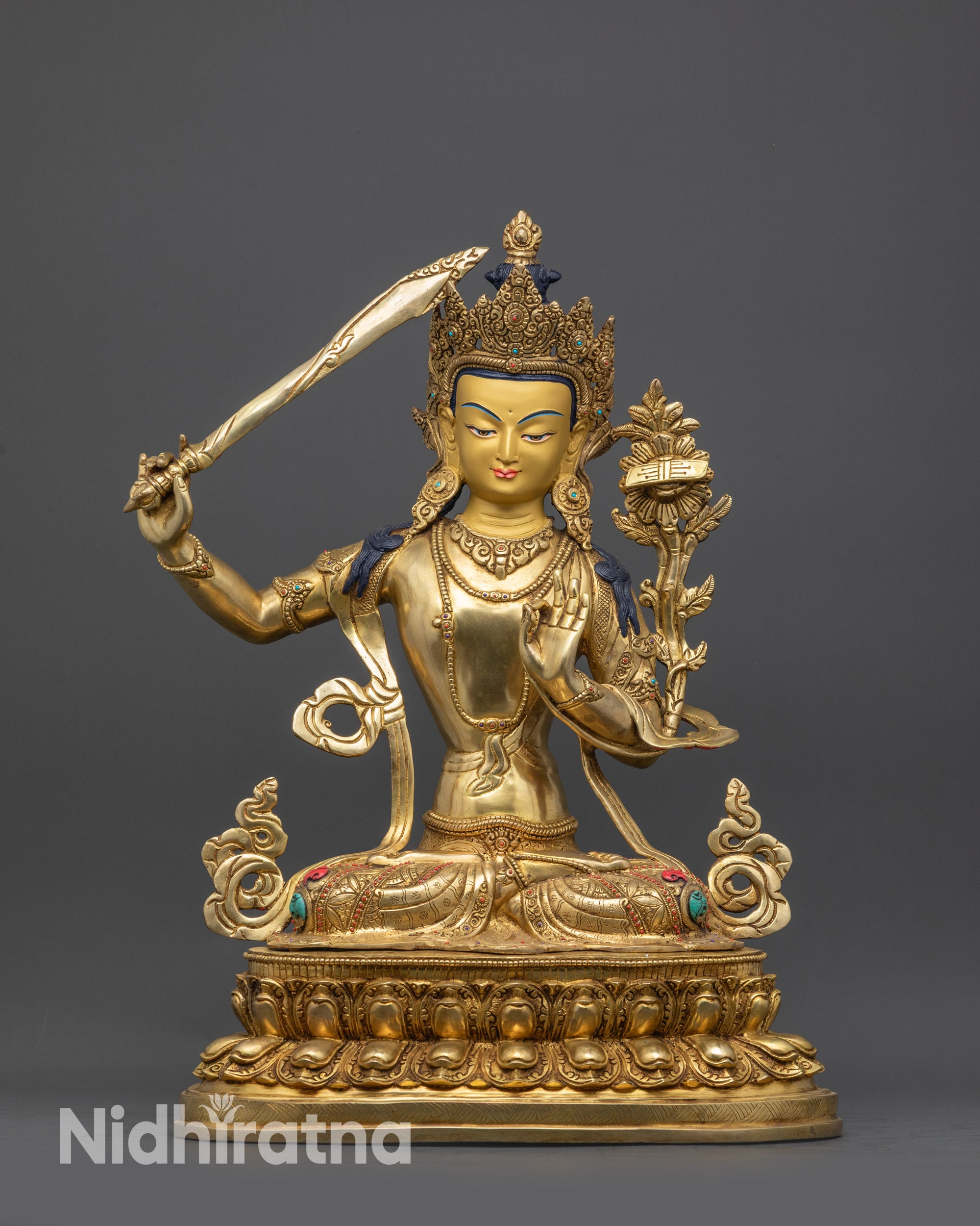 Front view Manjushri statue on lotus with gold fire-gilded face and robes