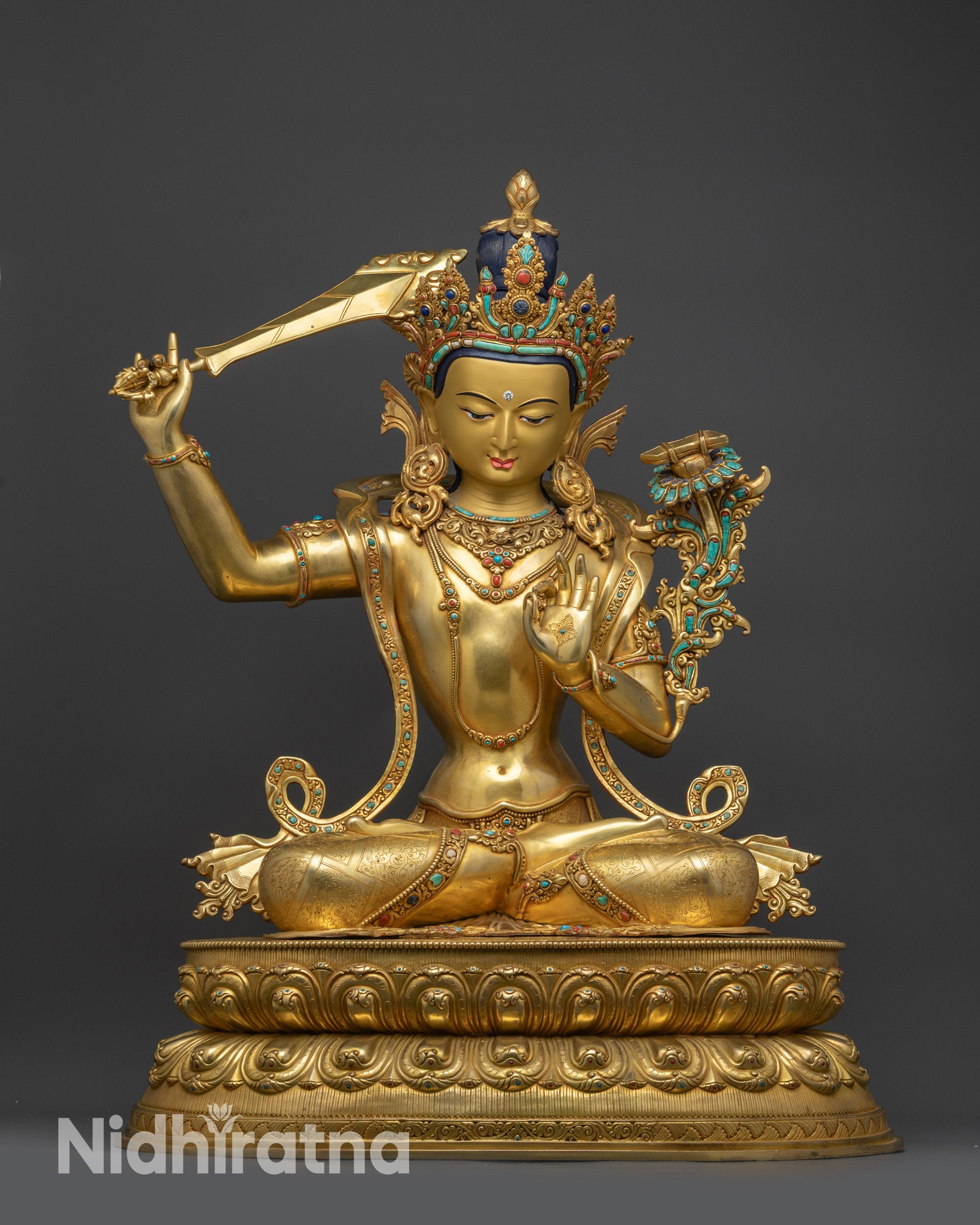 Front view Manjushri statue seated on lotus with gold-gilded Bodhisattva details