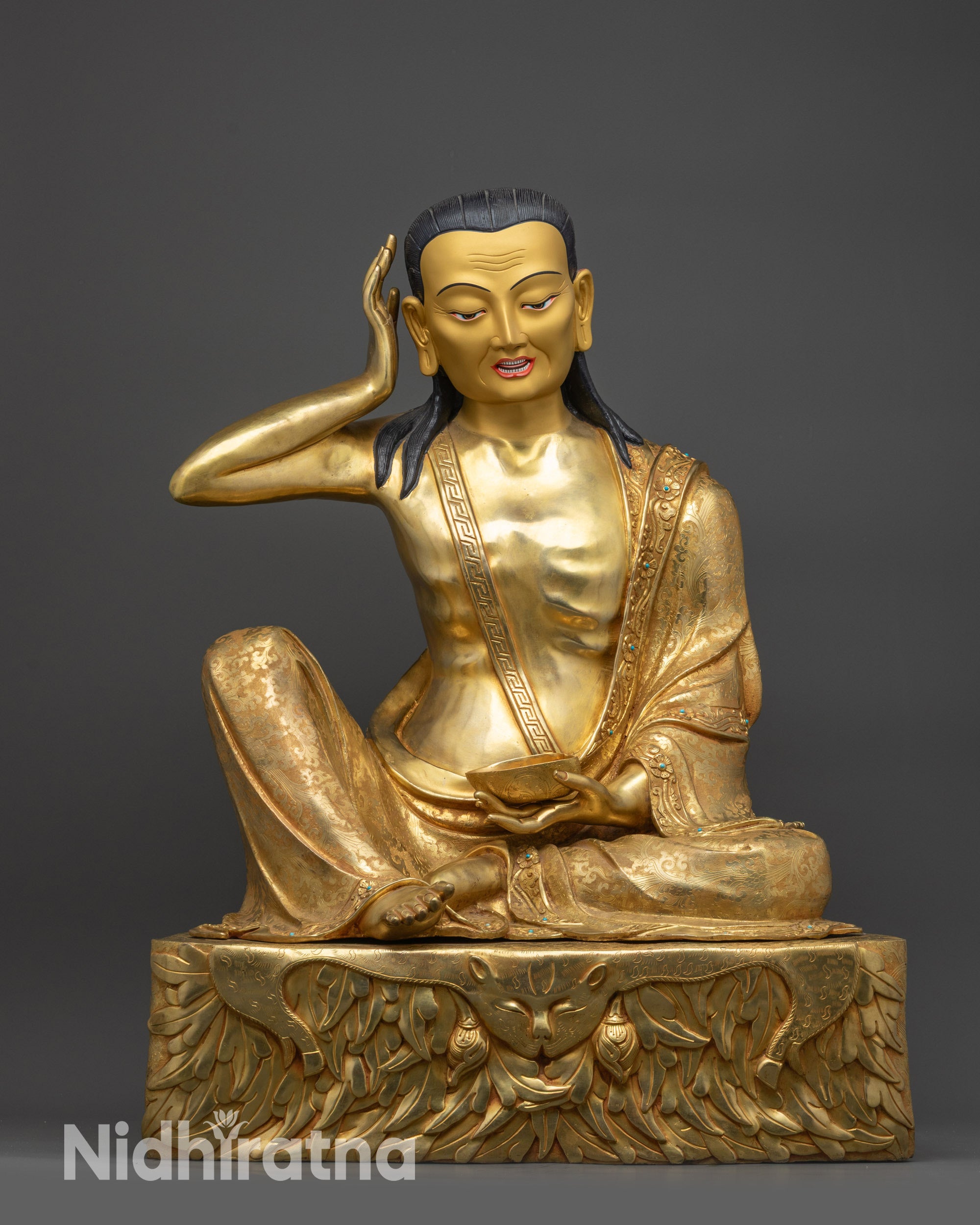 Front view Milarepa statue on gold fire-gilded base with intricate deer skin pedestal