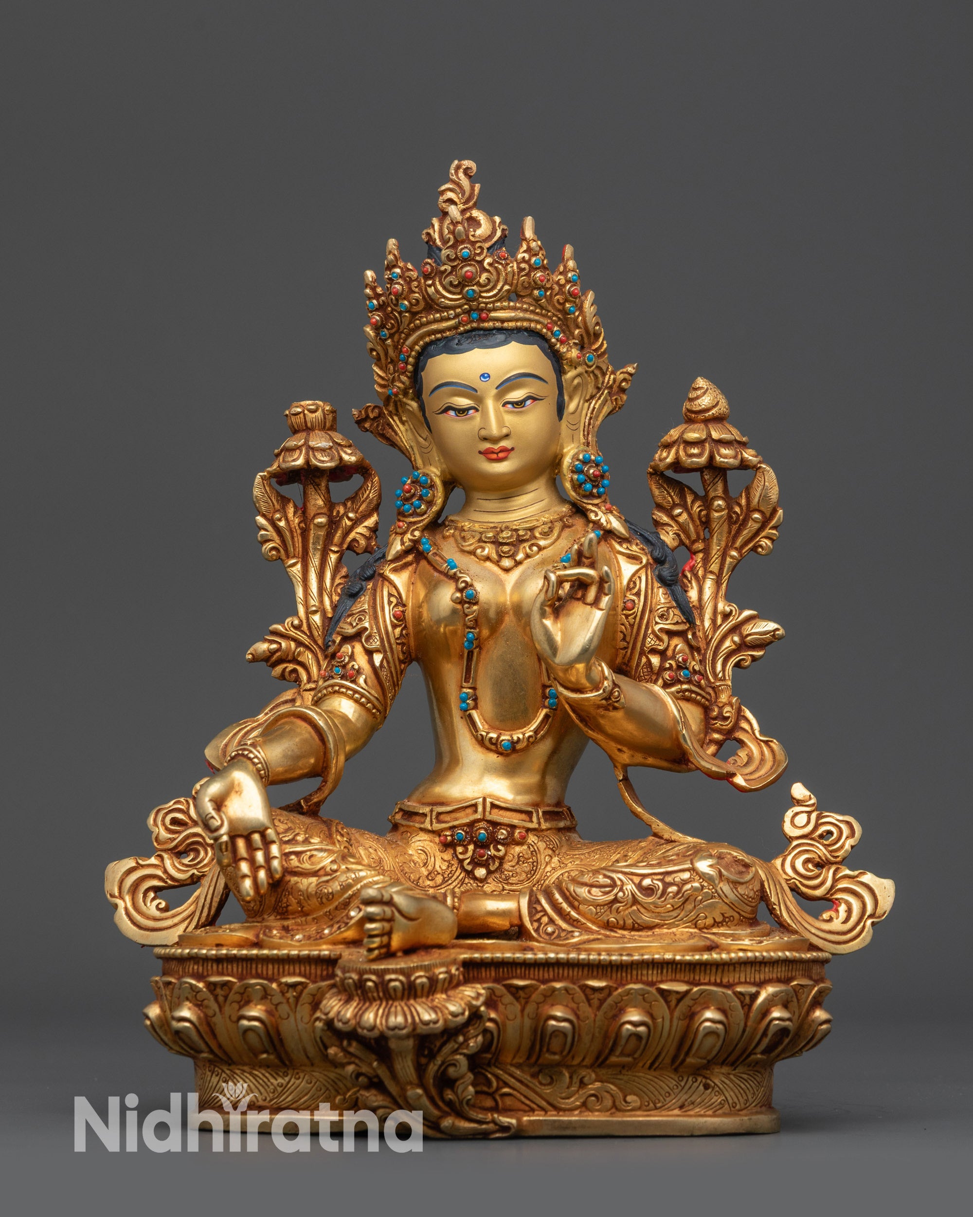 Front view Nepalese Green Tara statue in royal ease with gold-gilded face and lotus seat