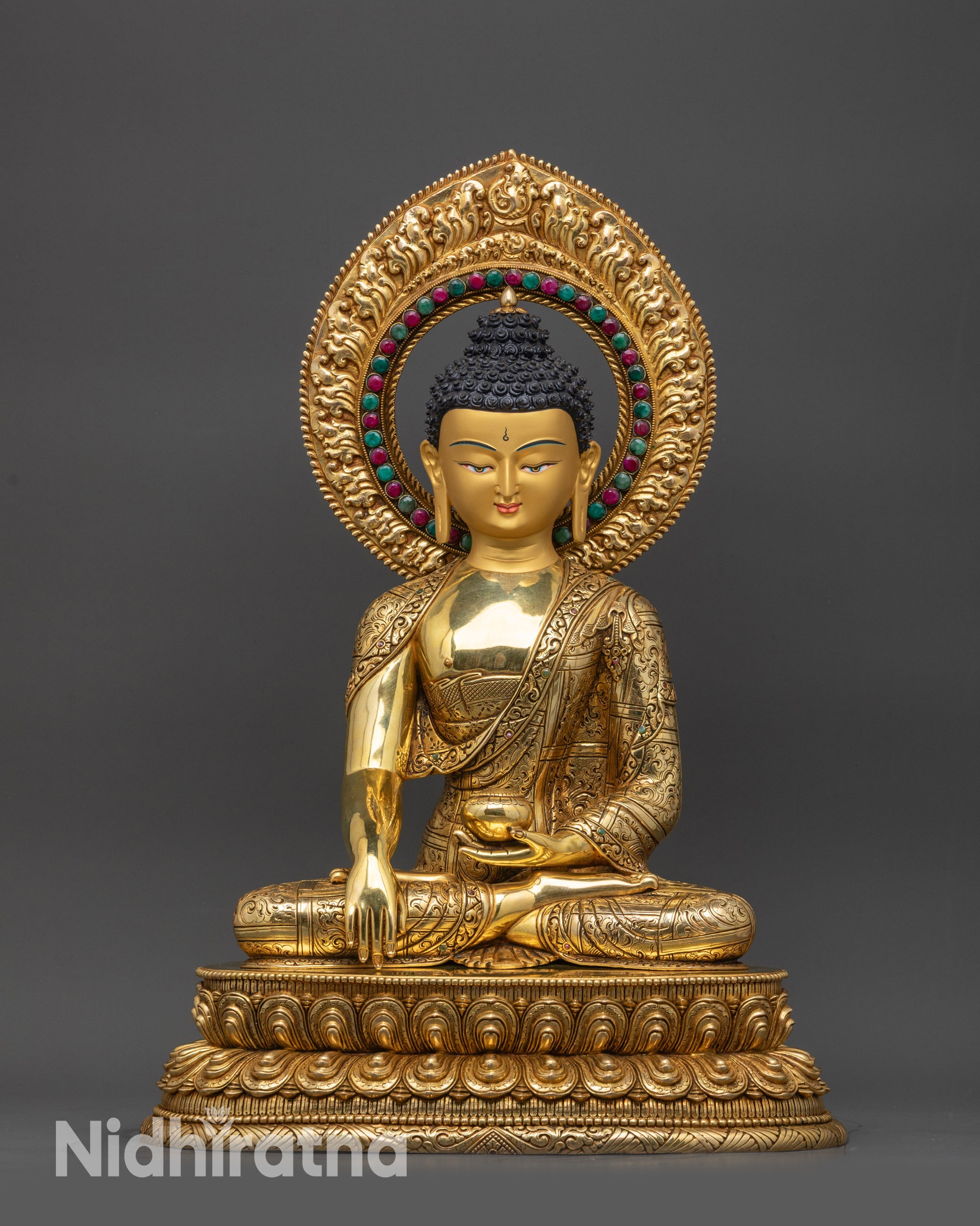 Front view Shakyamuni Buddha statue with lotus pedestal and gold-gilded body
