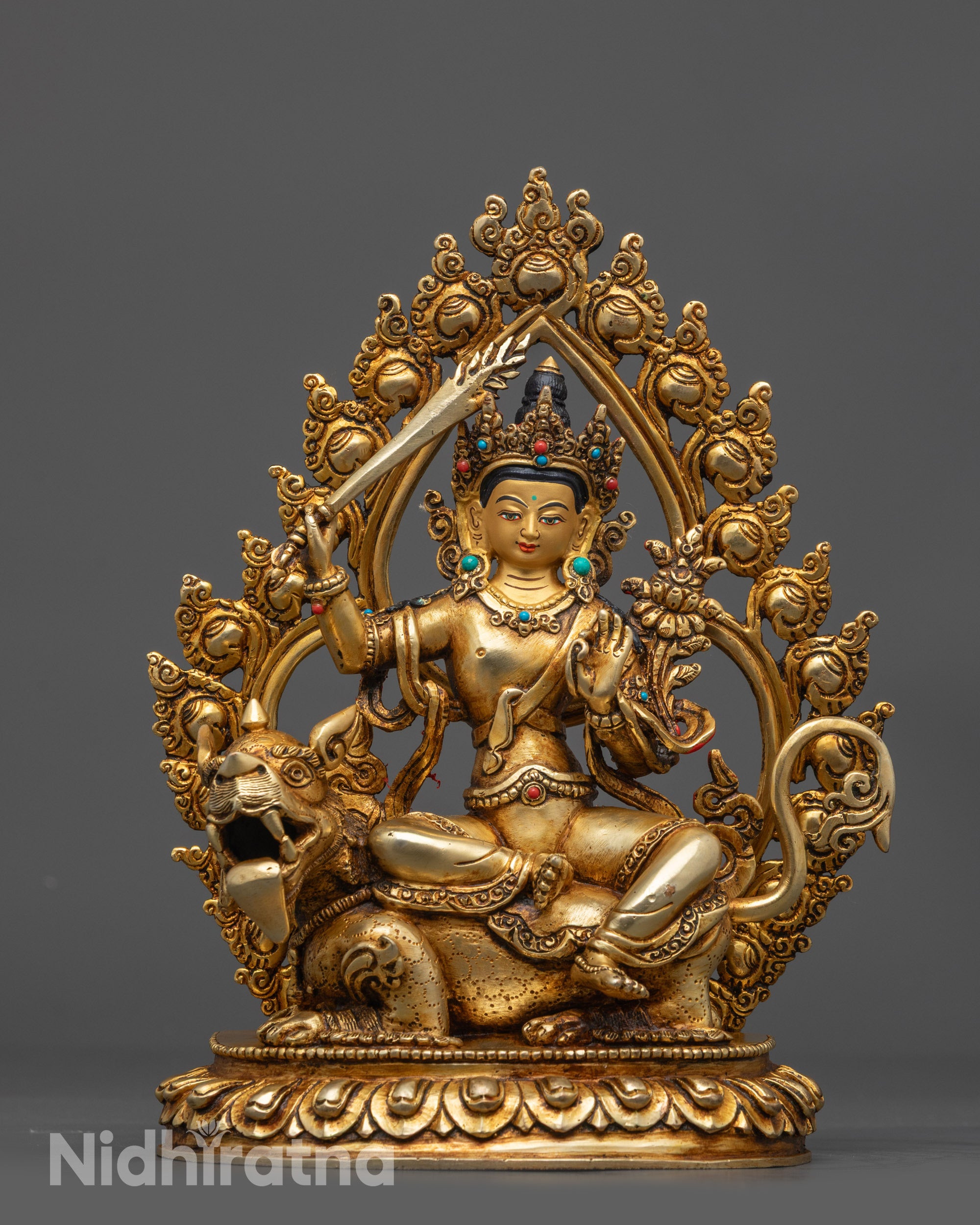Front view Simhada Manjushri Statue seated on lion with sword and scripture details