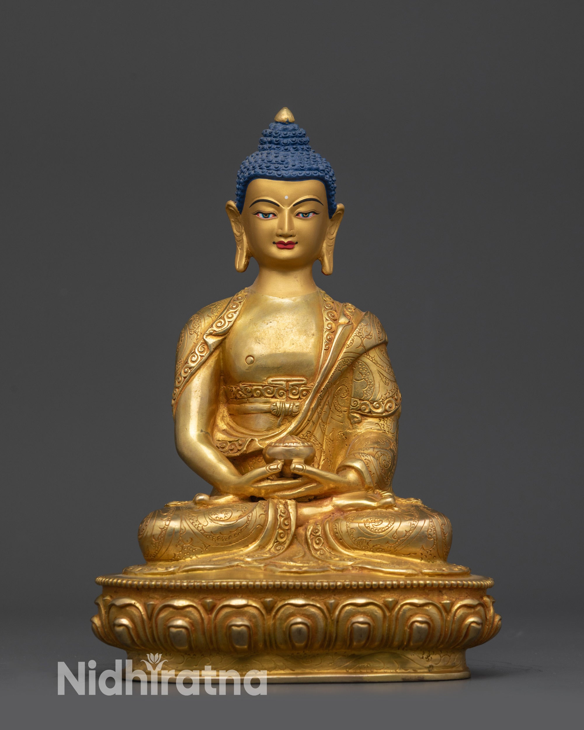 Front view gold fire-gilded Amitabha Buddha statue seated in lotus pose with monk robe