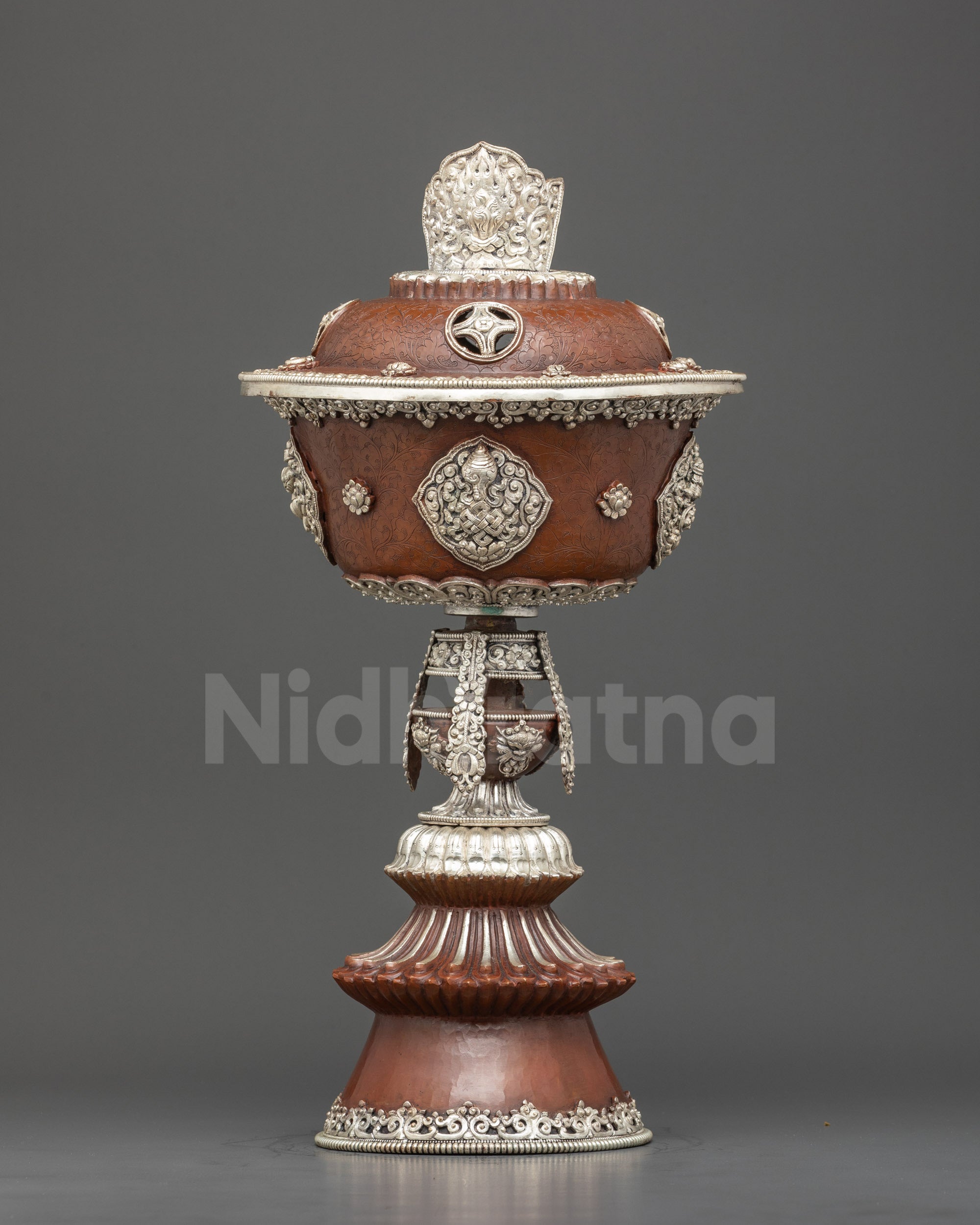 Front view handmade Tibetan Butter Lamp with silver plating, floral designs, and Buddhist symbols