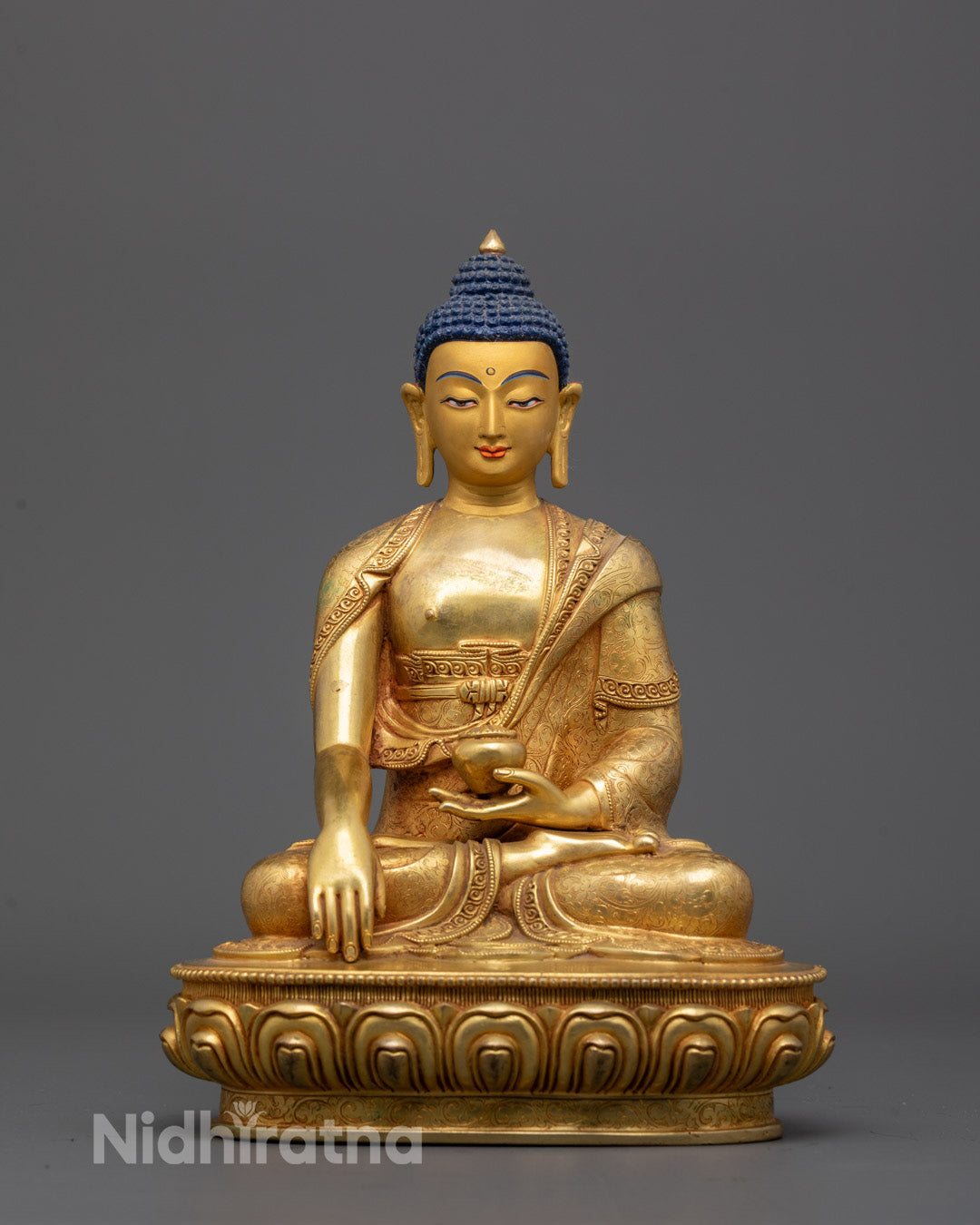 Front view of 24K gold-gilded Shakyamuni Buddha statue with lotus throne base