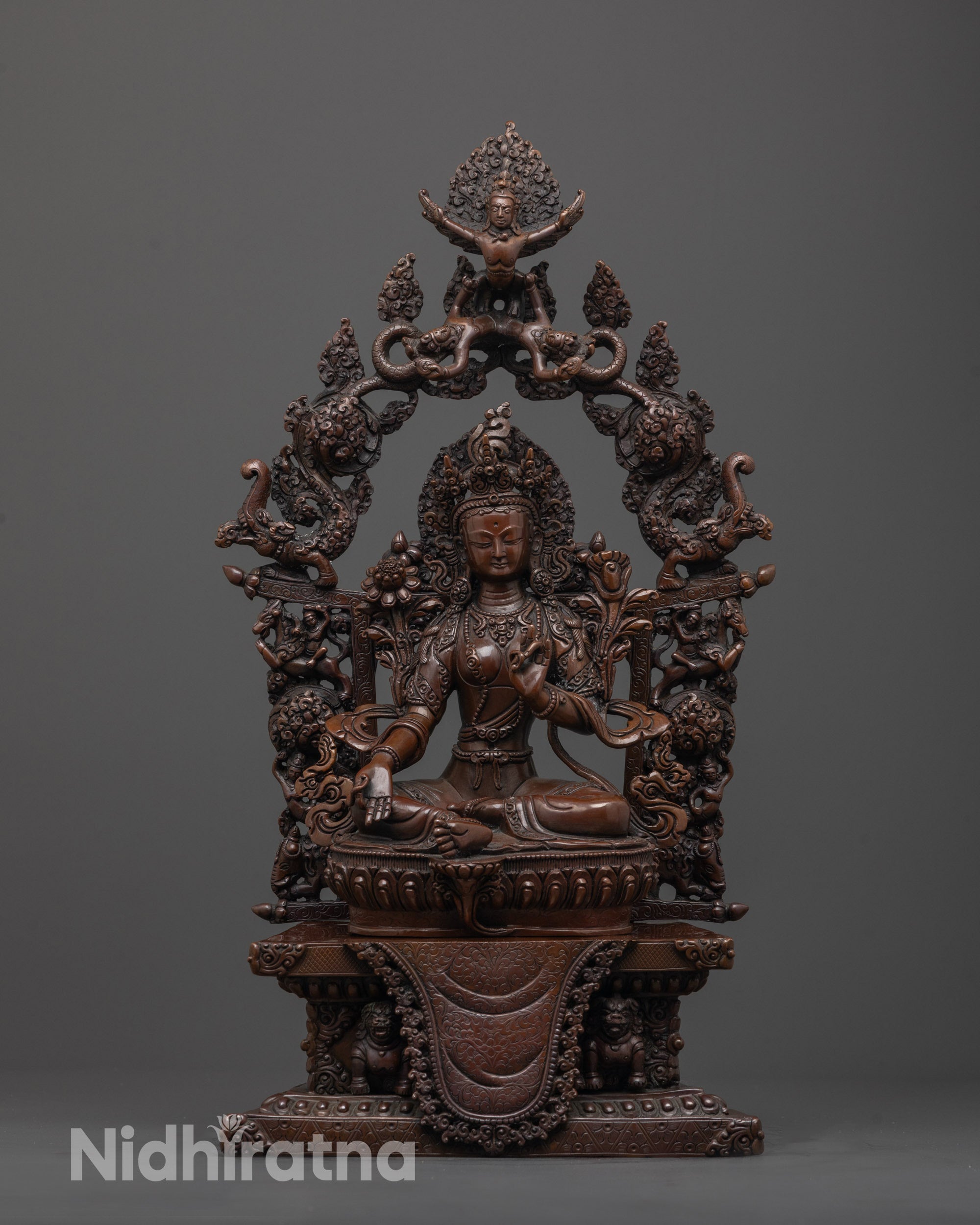Front view of Arya Tara Statue in oxidized copper with halo and lotus throne
