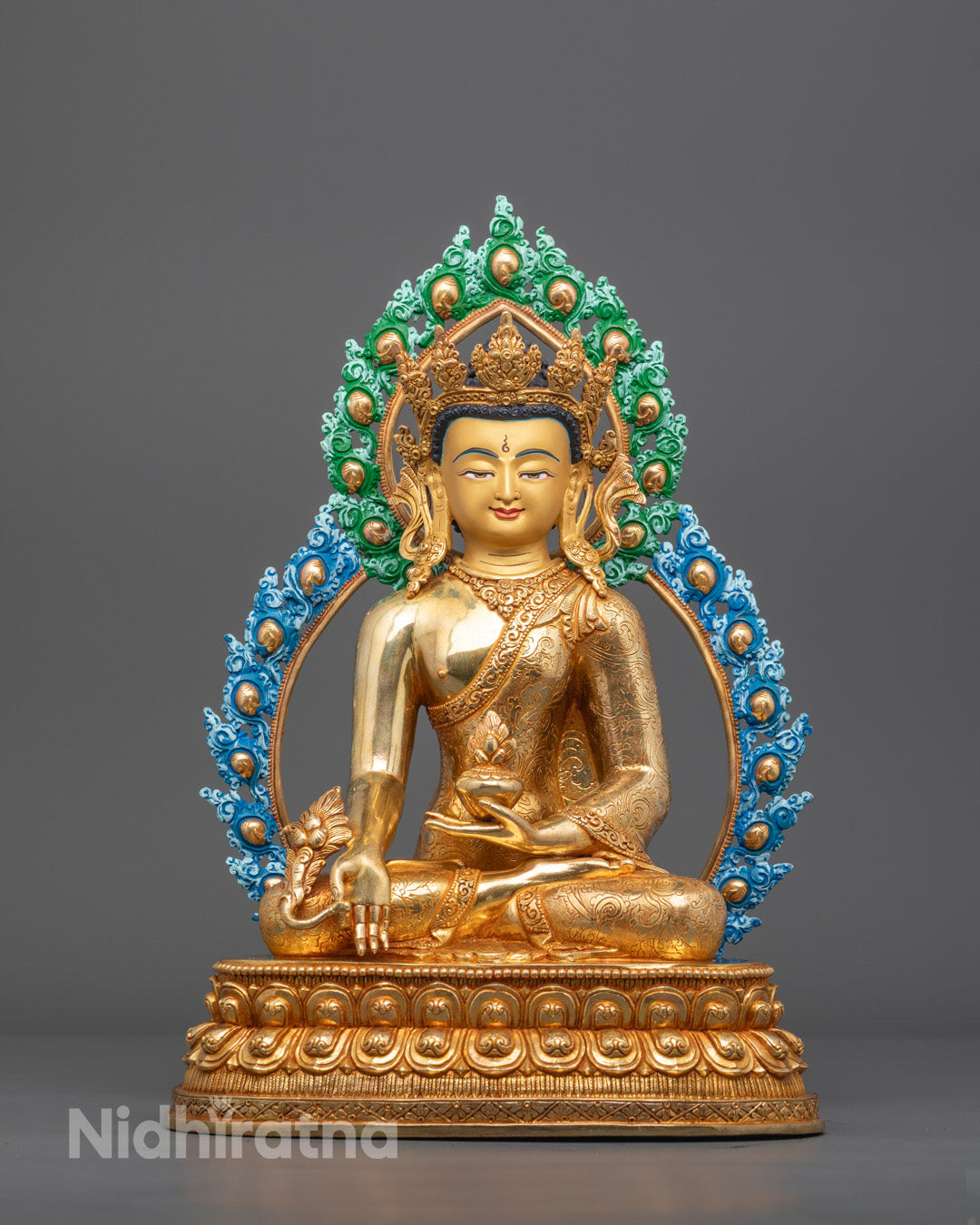 Front view of Bhaisajyaguru Healing Buddha statue with gold-gilded face and lotus throne