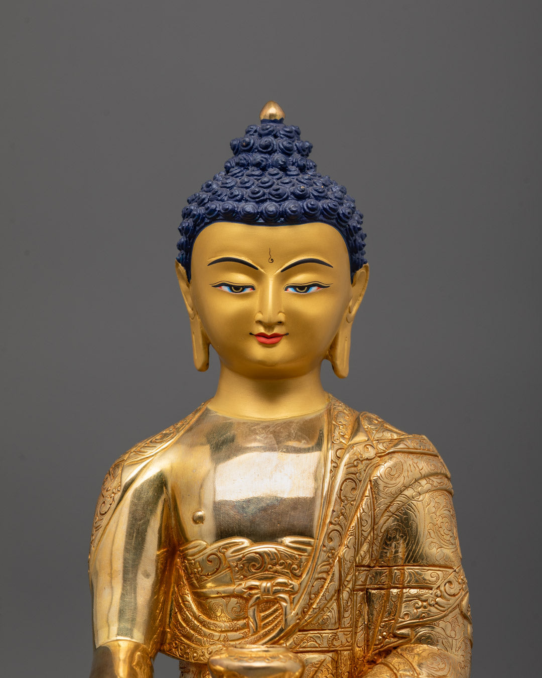 Front view of Buddha statue in meditation posture with peaceful and serene expression