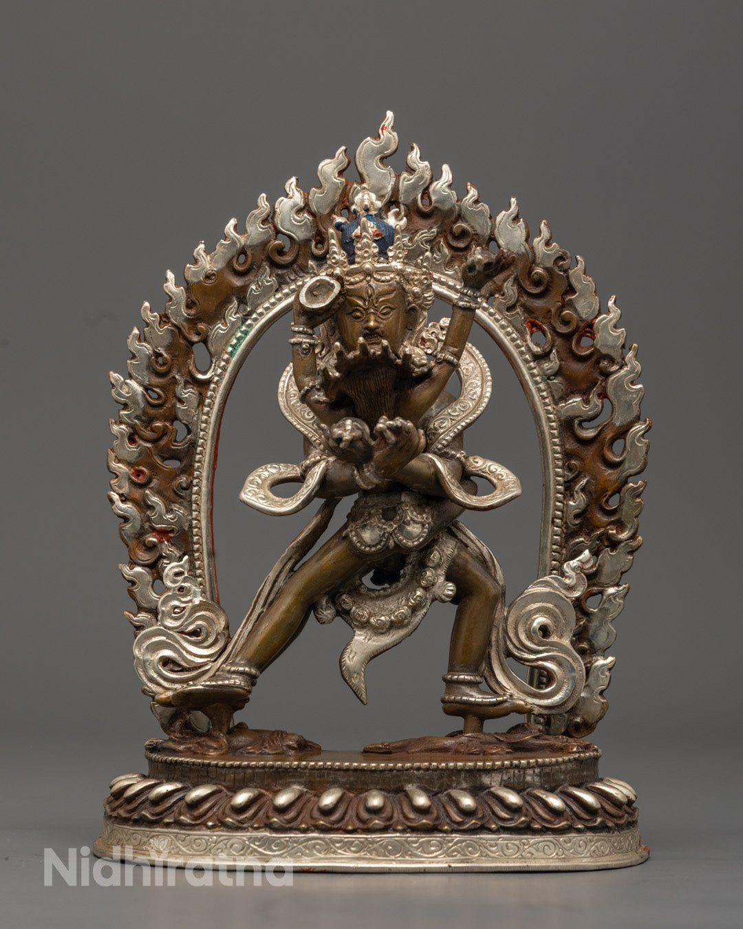Chakrasamvara statue with multiple arms, made from oxidized copper with silver plating and vibrant acrylic colors