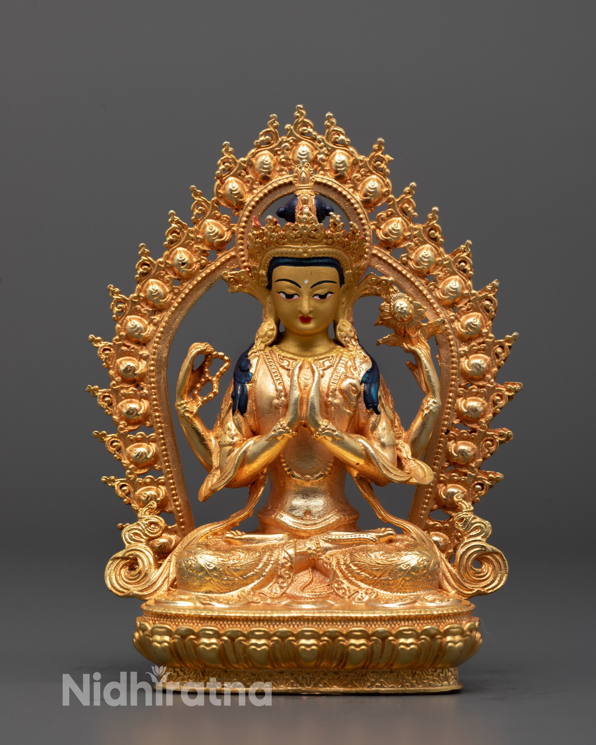 Front view of Chenrezig Statue seated on a lotus base with a peaceful expression