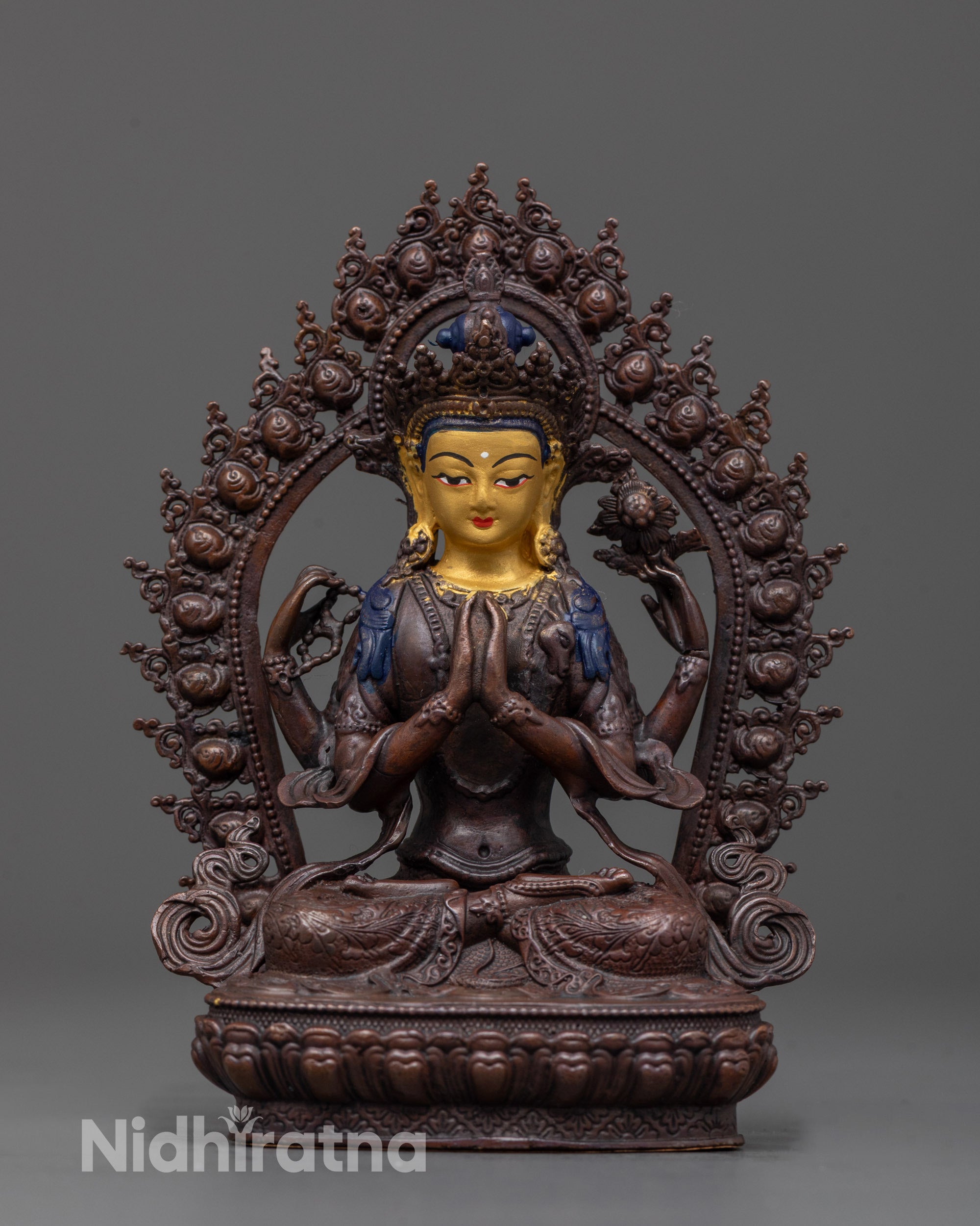 Front view of Chenrezig statue with gold-plated face and oxidized copper body in earthy tones