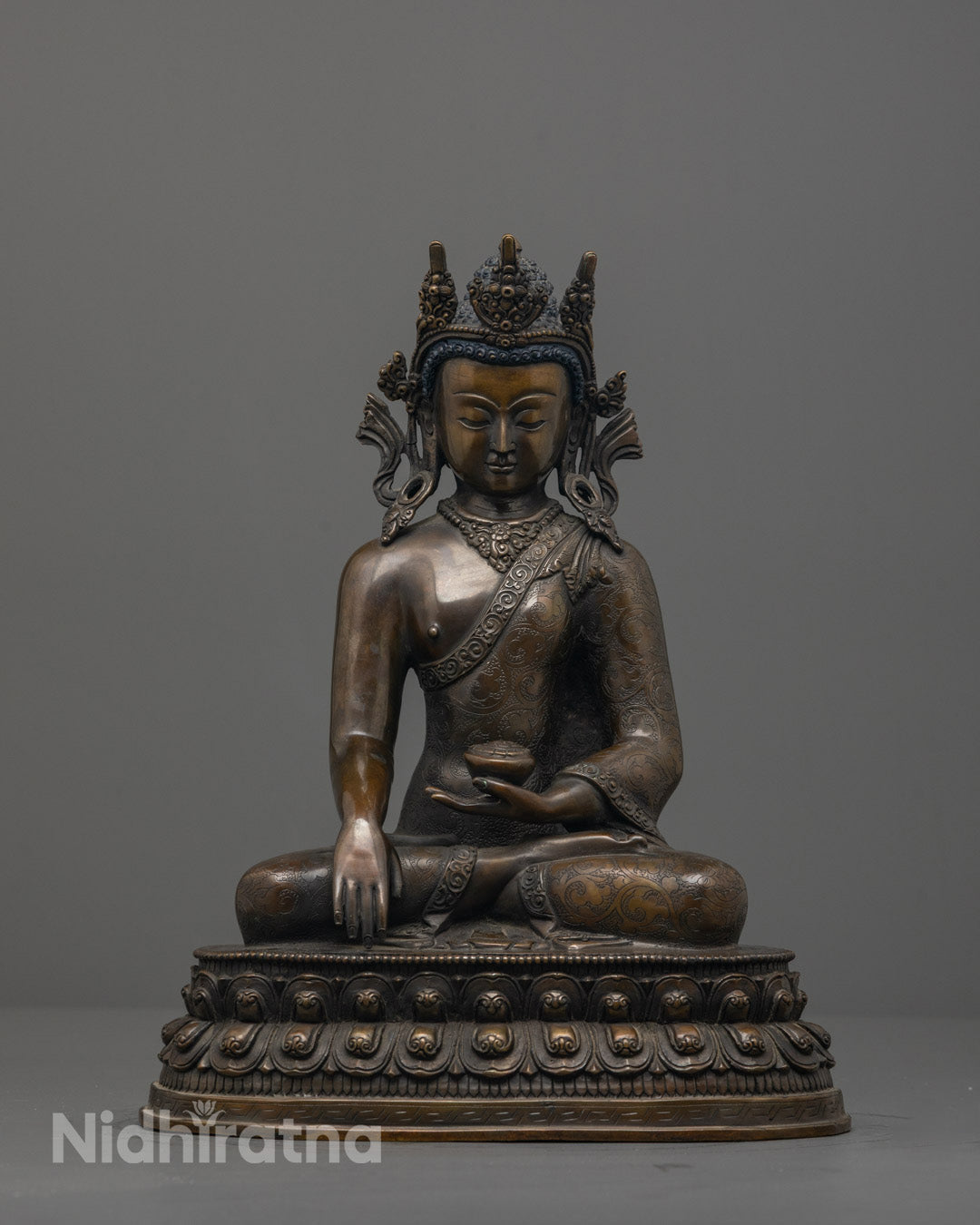Front view of Crowned Shakyamuni Buddha Statue with detailed crown and patra bowl