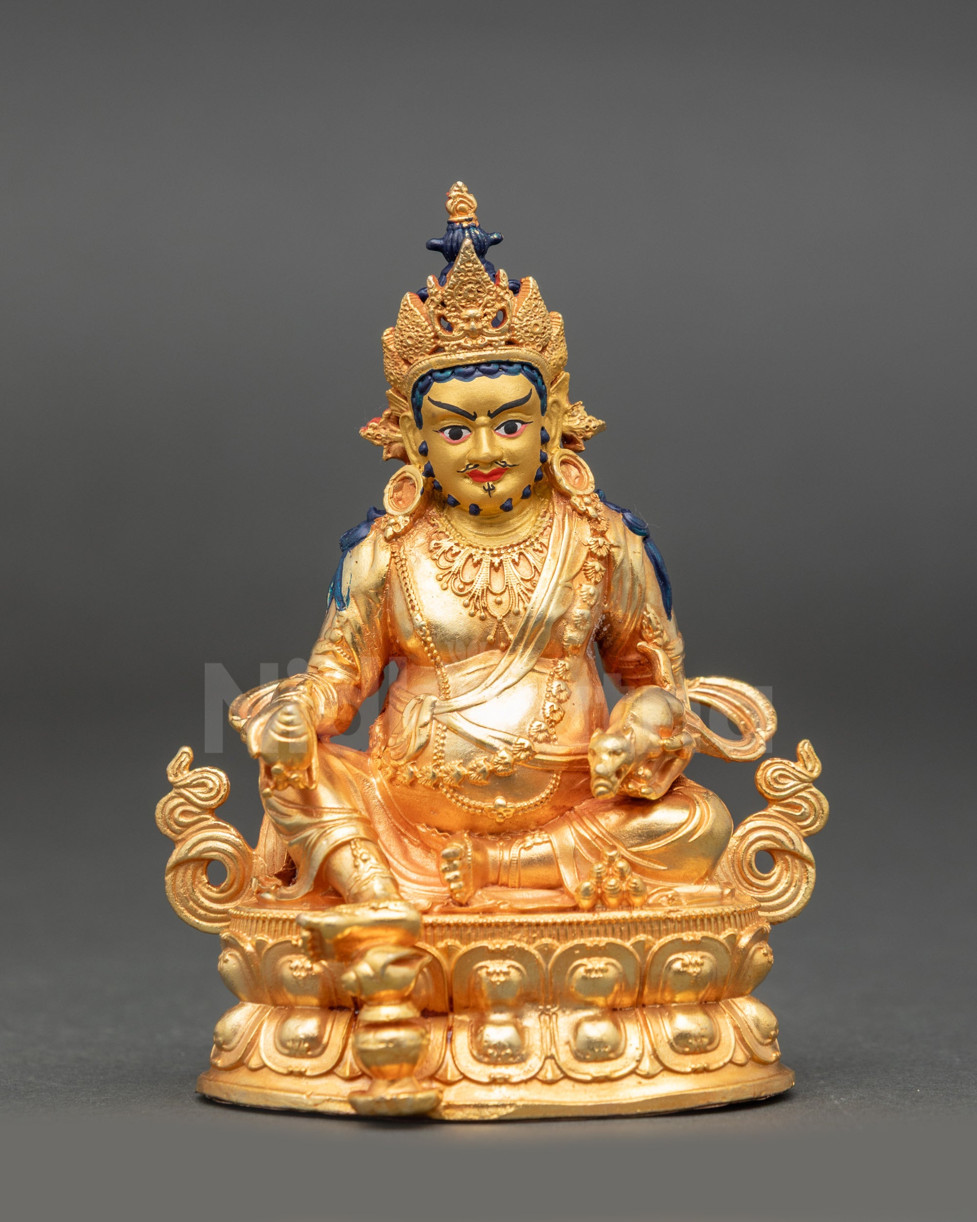 Front view of Dzambhala Buddhist deity statue adorned with crown, jewelry, and tiger-skin
