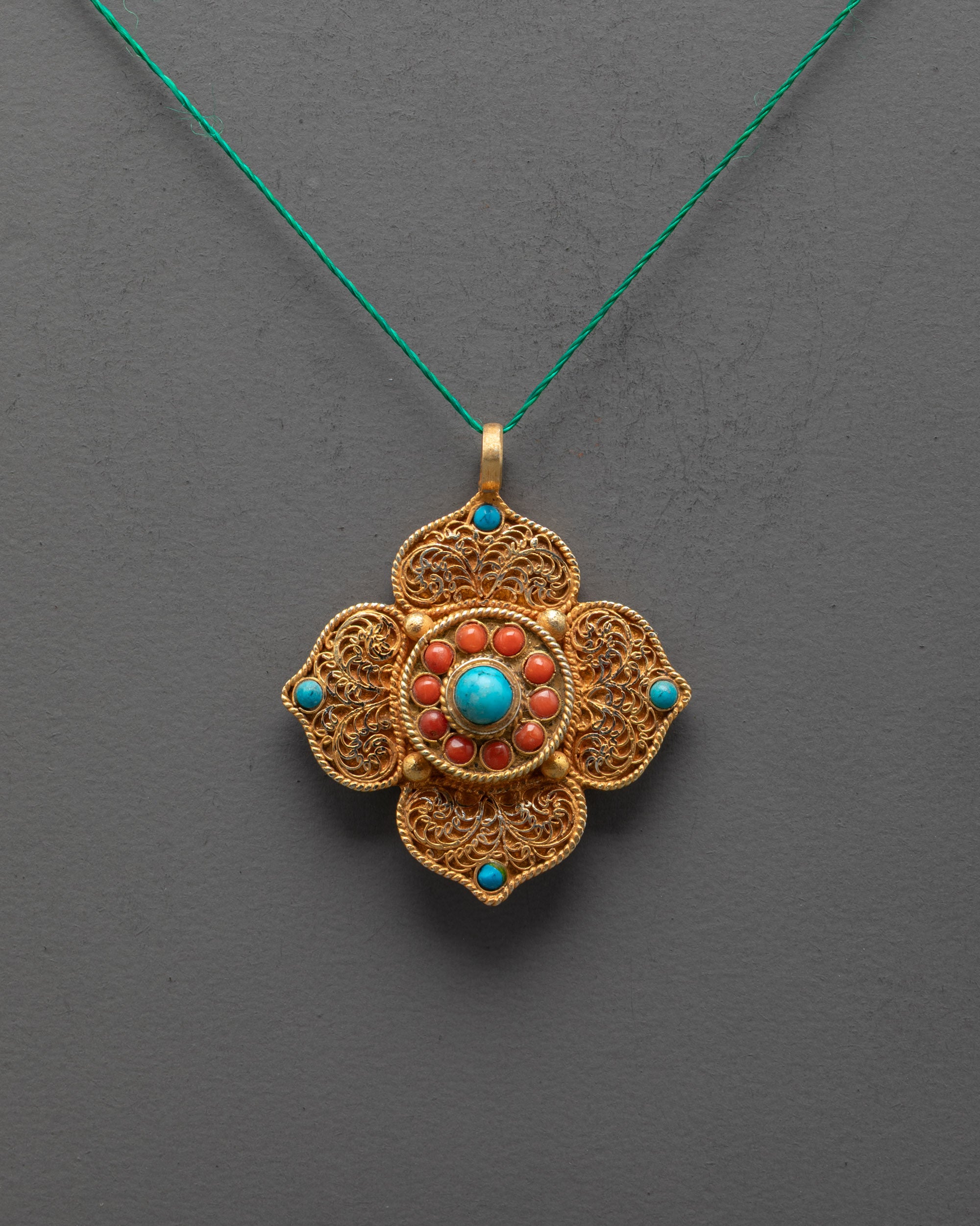 Front view of Elegant Lotus Locket with turquoise and coral stones, handcrafted in Nepal