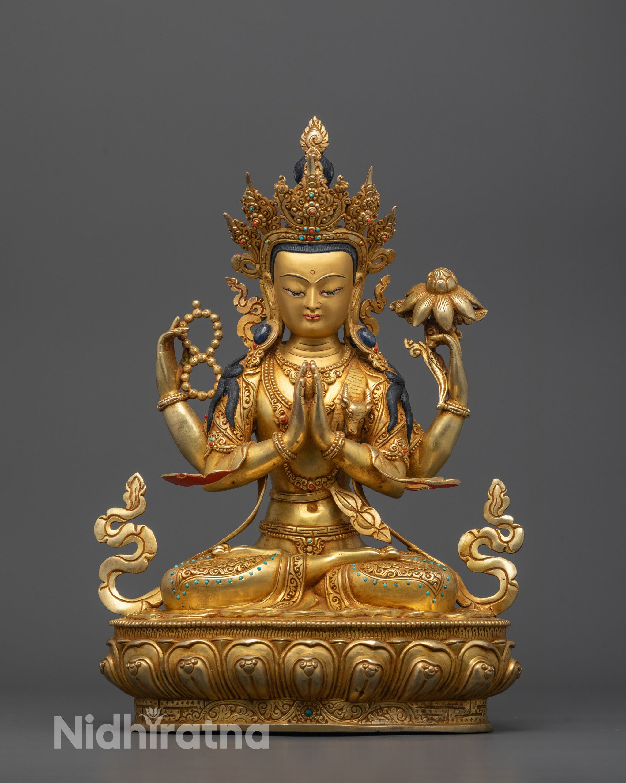 Front view of Four-Armed Chenrezig Statue seated on a lotus base with crystal rosary