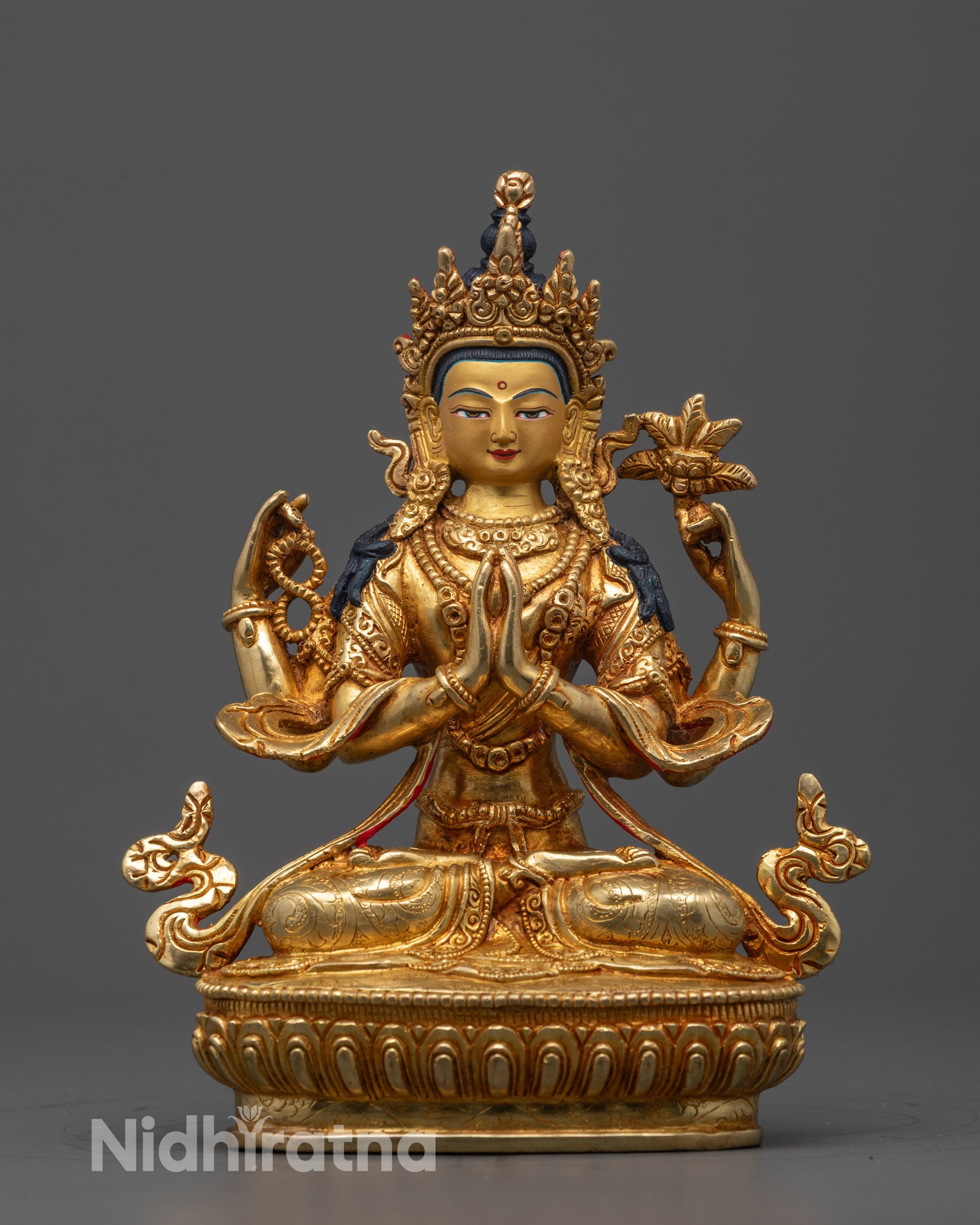 Front view of Four-Armed Chenrezig Statue seated on lotus base with symbolic objects