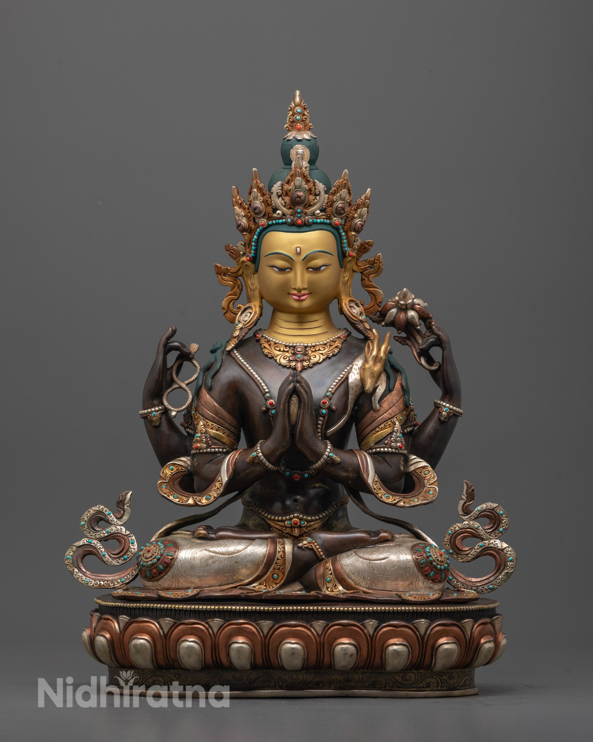 Front view of Four-Armed Chenrezig Statue with gold-gilded face and seated on moon disc lotus base